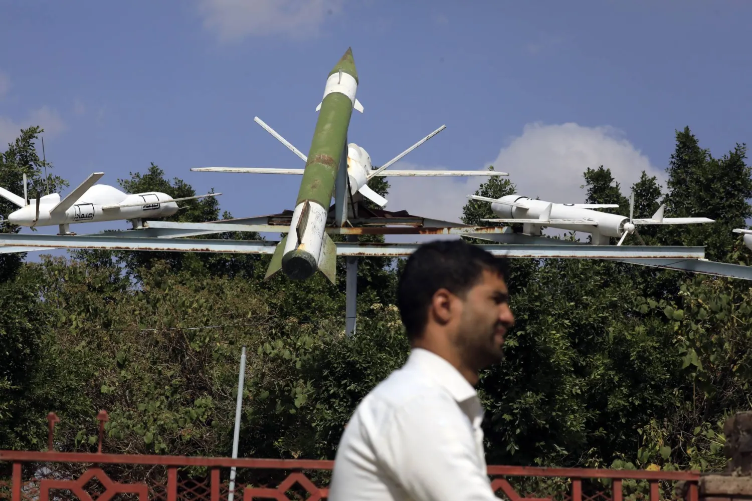 A person passes a display of Houthi-made mock missile and drones at a square in Sanaa, Yemen, 01 December 2024. EPA/YAHYA ARHAB