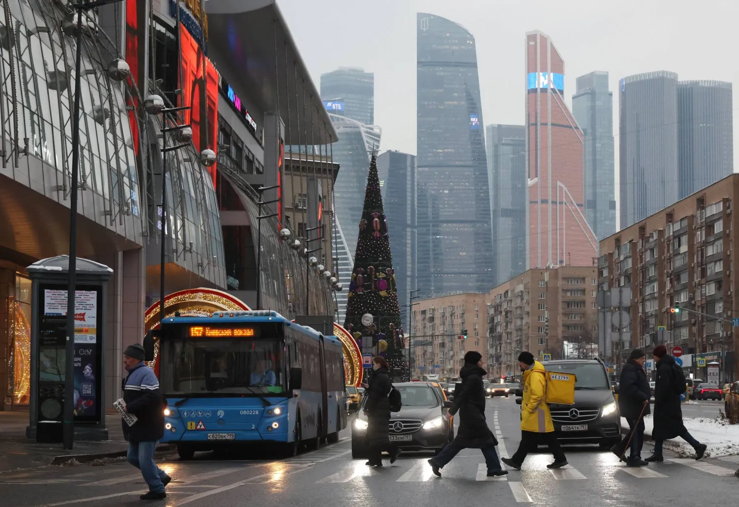 A street with Christmas and New Year decorations near the business center Moscow-City (background) in Moscow, Russia 10 December 2024. EPA/MAXIM SHIPENKOV