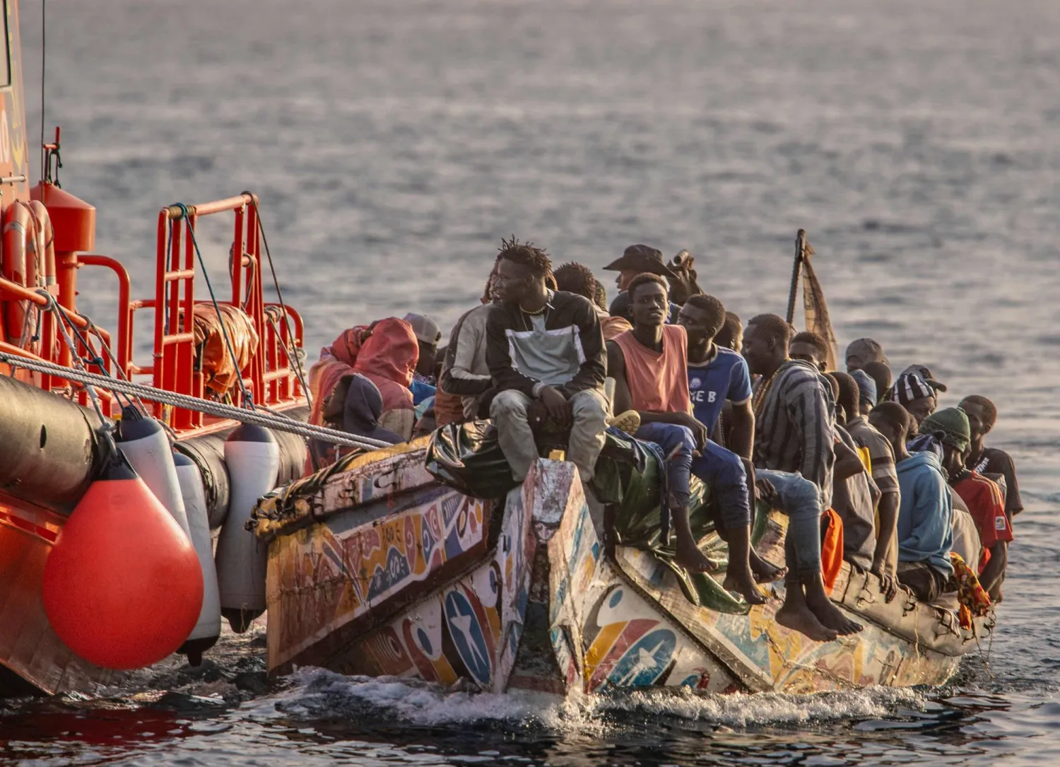 (FILES) A 'cayuco' boat from Senegal with 136 migrants onboard arrives after being rescued at sea by a Spanish Salvamento Maritimo vessel, at La Restinga port on the Canary island of El Hierro, on November 28, 2024. (Photo by Antonio SEMPERE / AFP)