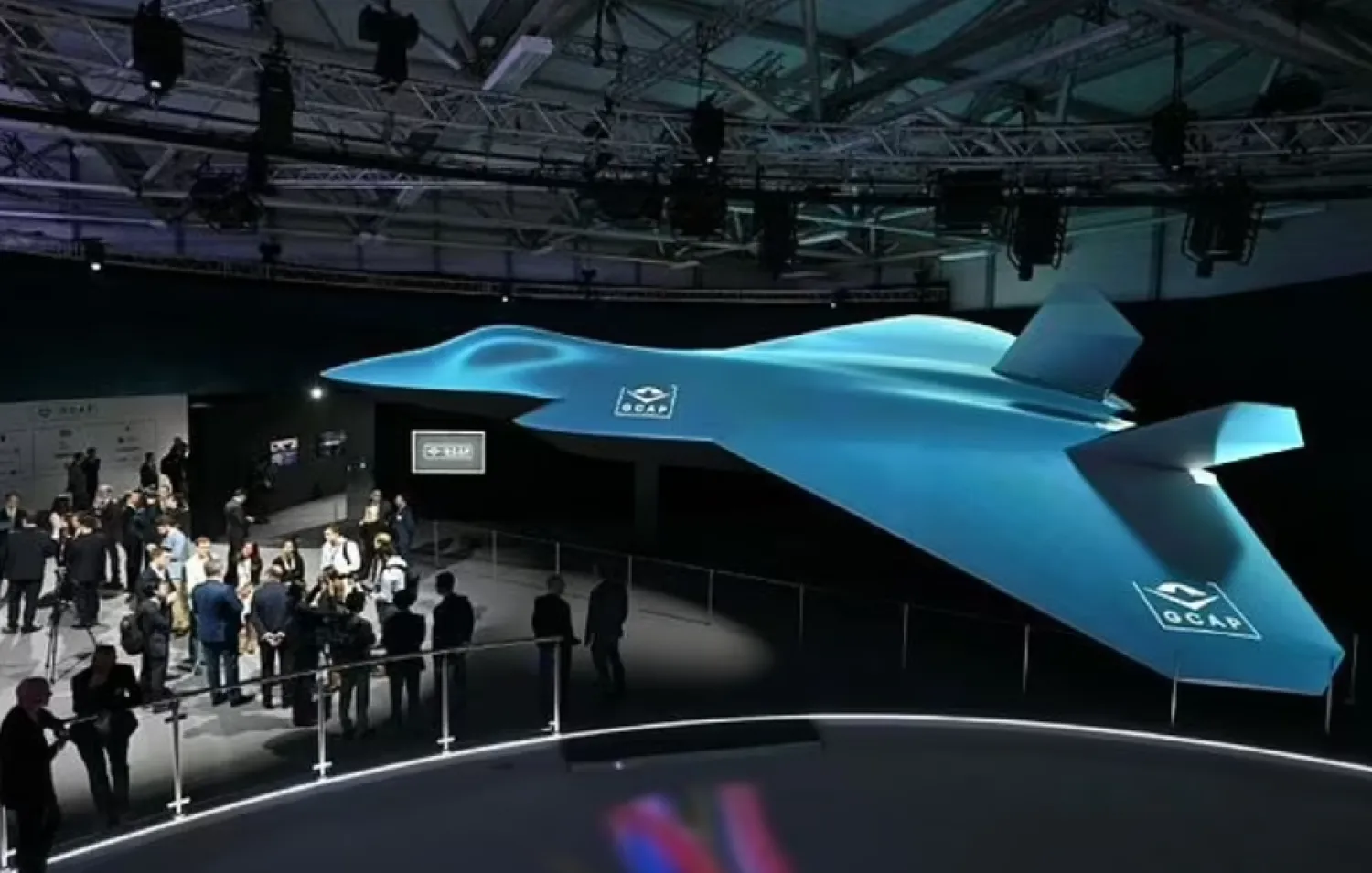 Delegates look at the Global Combat Air Program (GCAP) 6th generation fighter jet concept design at the Farnborough International Airshow 2024 - AFP


