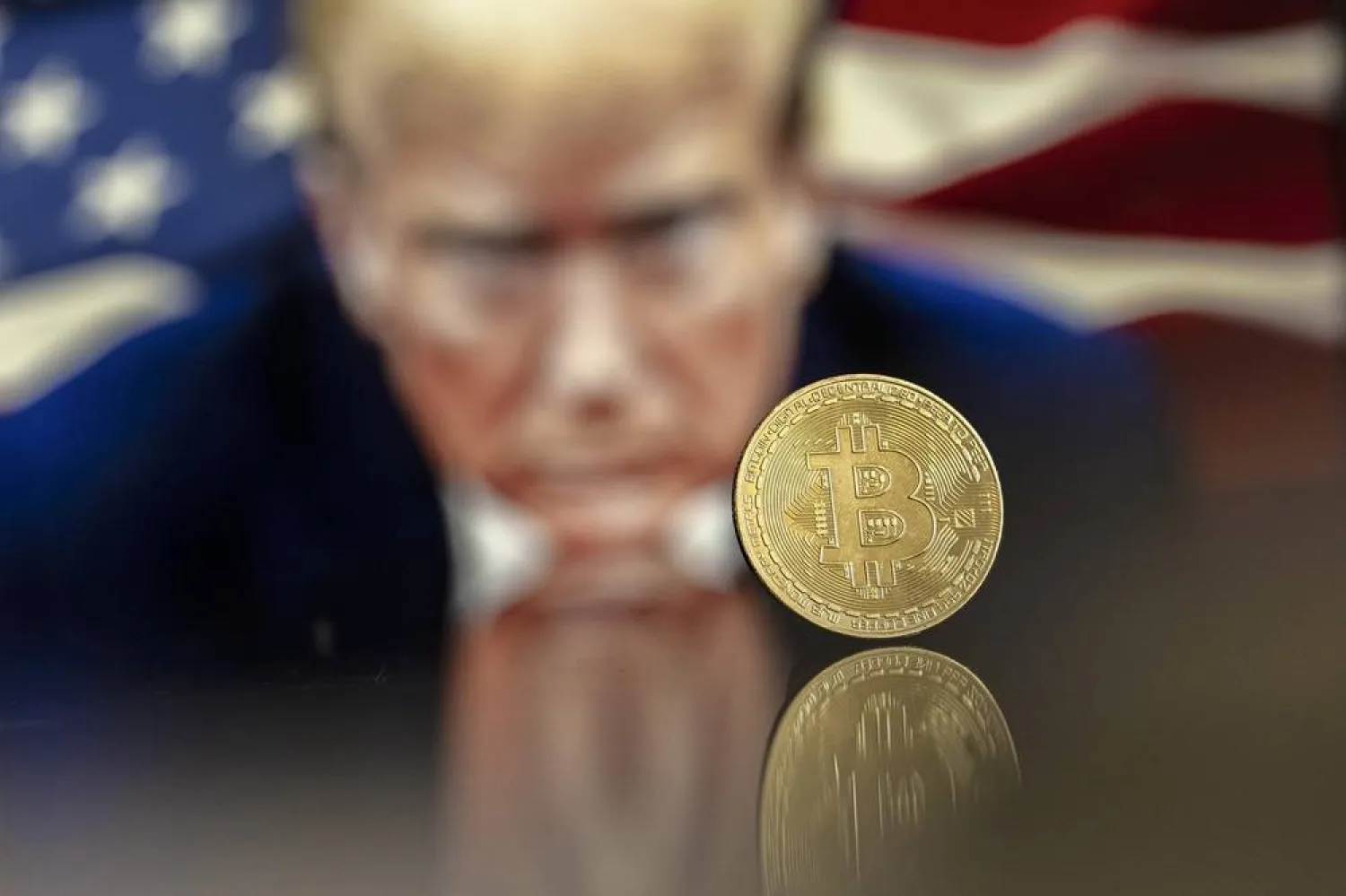 An illustration shows a Bitcoin mockup in front of an image of US President-elect Donald Trump, 22 November 2024 (reissued 16 December 2024). (EPA)