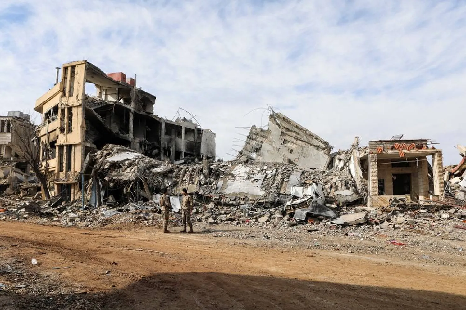  Lebanese army members stand near rubble at a damaged site after the ceasefire between Israel and Hezbollah, in the Lebanese village of Khiam, December 23, 2024. (Reuters)