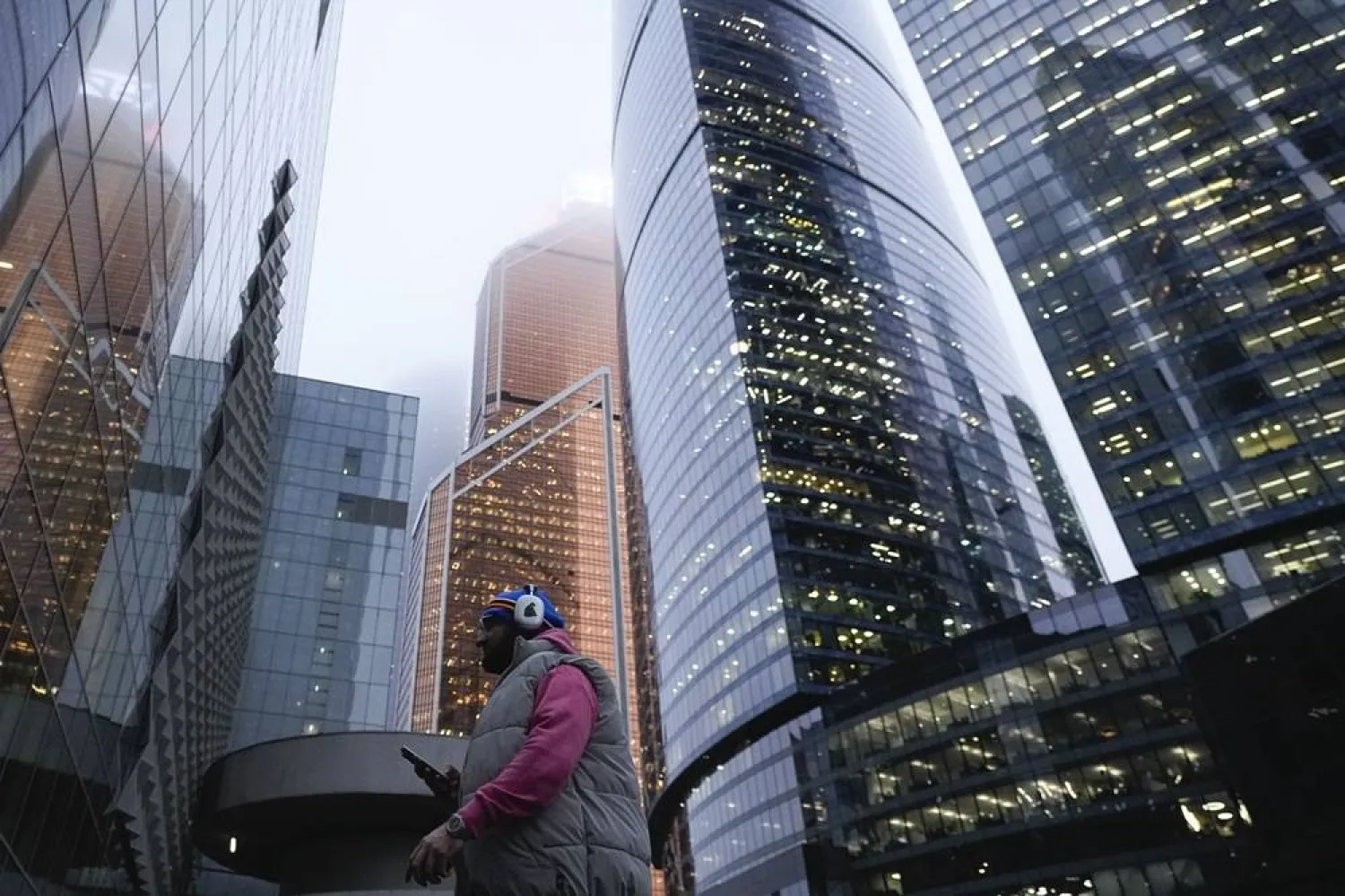  A man walks next to the skyscrapers of the Moscow City business district in Moscow, Russia, Friday, Dec. 27, 2024. (AP)
