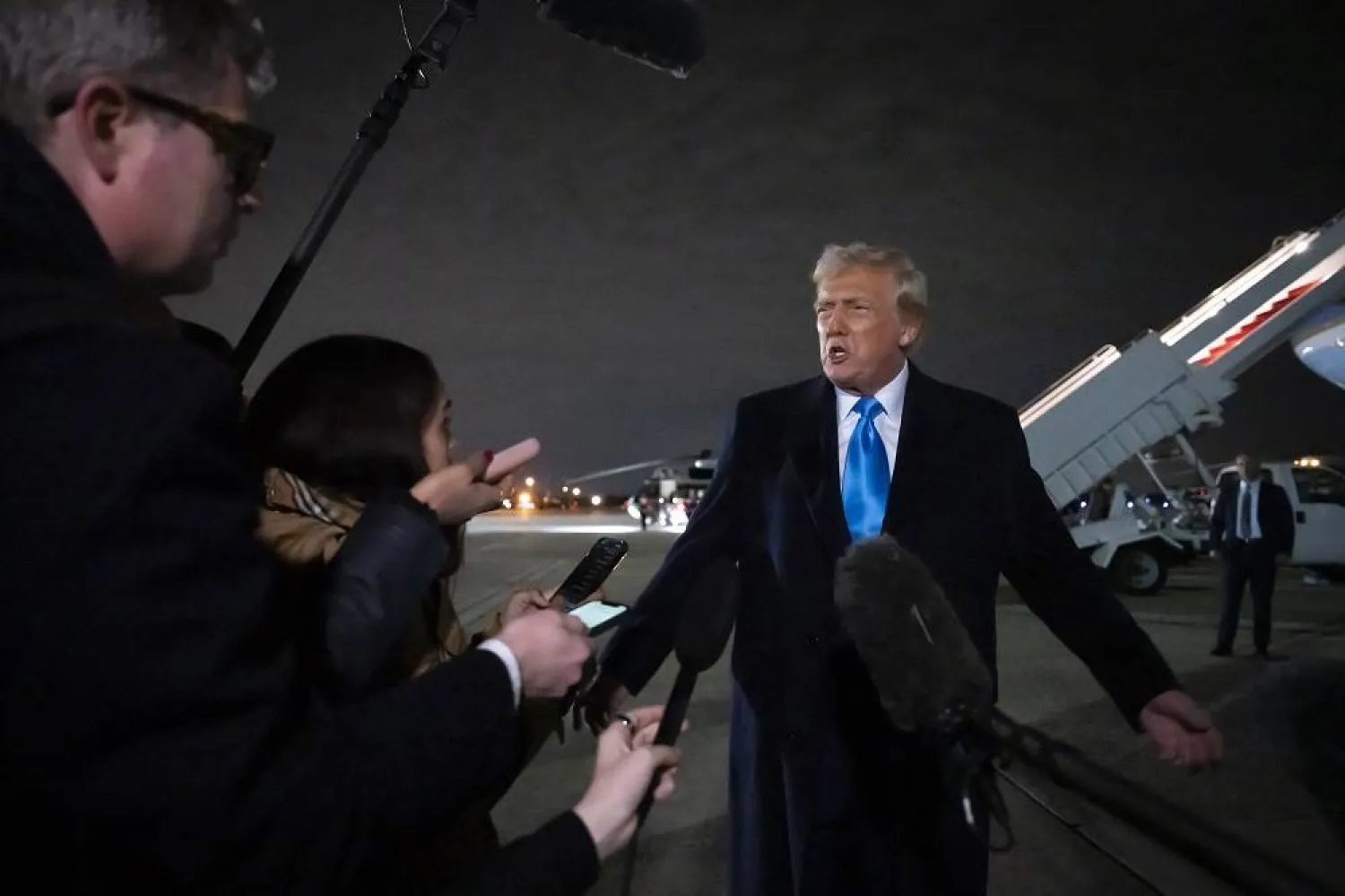 President Donald Trump speaks to reporters next to Air Force One after arriving back at Joint Base Andrews, Md., Sunday, Feb. 2, 2025. (AP)