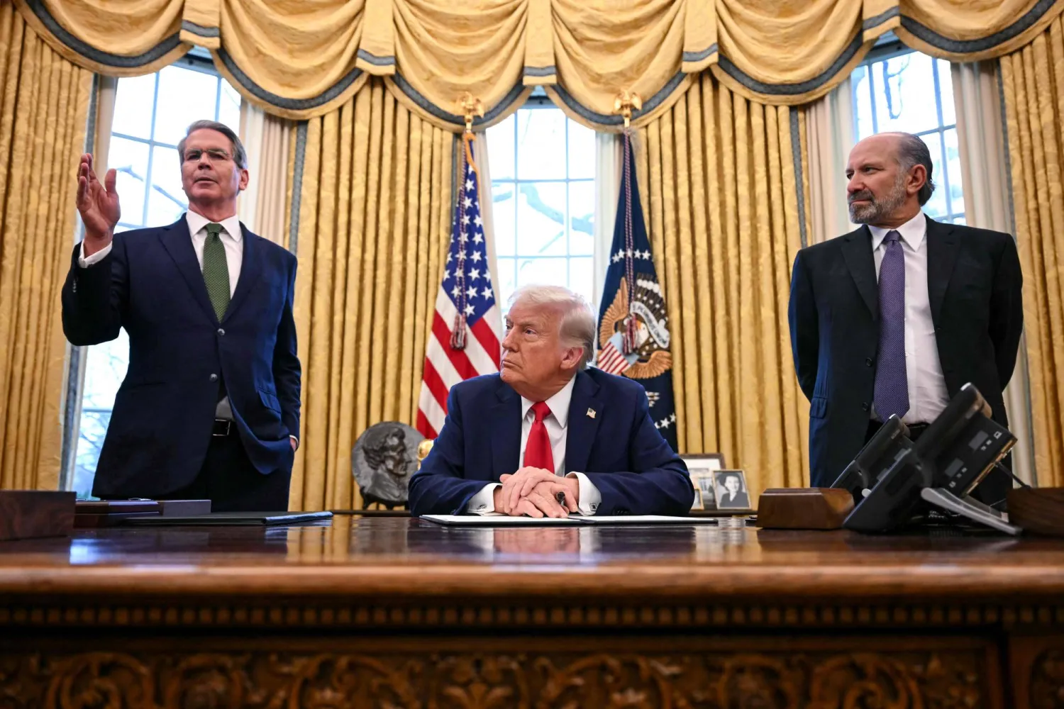 وزير الخزانة سكوت بيسنت يتحدث بينما يشاهده ترمب والمرشح لمنصب وزير التجارة هوارد لوتنيك بعد توقيع أمر لإنشاء صندوق ثروة سيادي (أ.ف.ب)