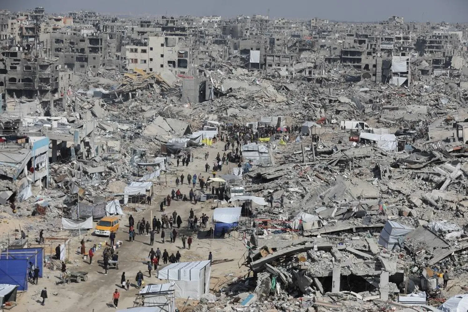 Palestinians walk through the rubble of houses and buildings destroyed during the Israeli offensive, amid a ceasefire between Israel and Hamas, in Jabalia refugee camp in the northern Gaza Strip January 29, 2025. (Reuters)