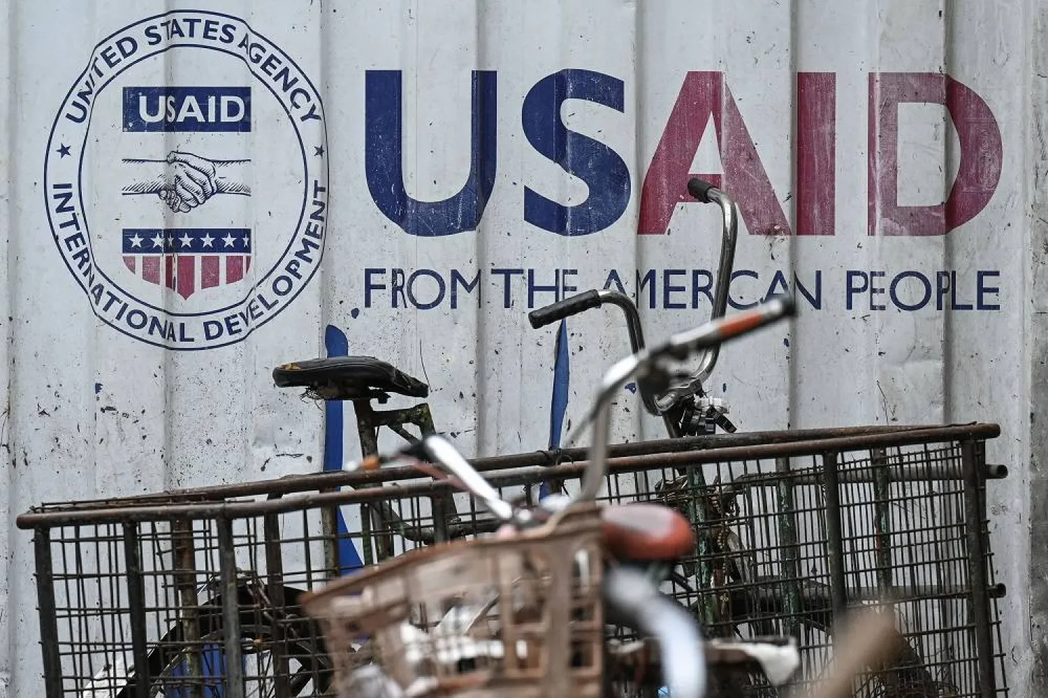 Signage for the US government's humanitarian agency USAID is seen on a cargo container beside a tricycle in Manila on February 4, 2025. (AFP)