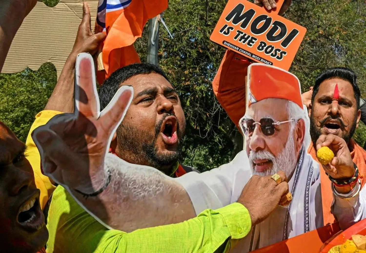 Supporters of the Bharatiya Janata Party (BJP) celebrate as BJP leads in vote counting for the Delhi legislative assembly election outside the party's state headquarters in New Delhi on February 8, 2025. (AFP)