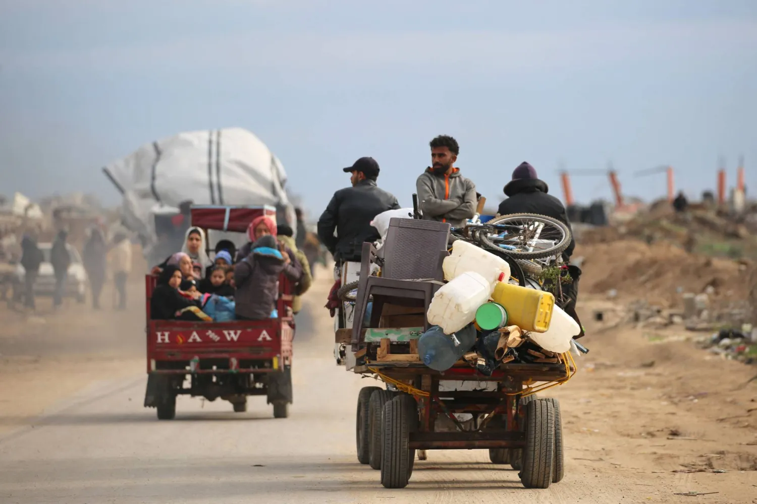 Displaced Palestinians cross the Netzarim corridor as they make their way to the northern parts of the Gaza Strip on February 9, 2025. (Photo by Eyad BABA / AFP)