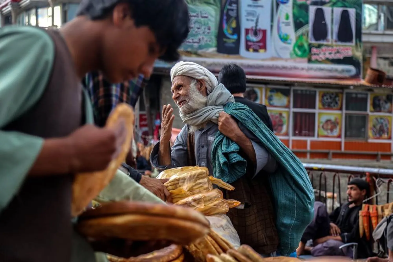 Afghan vendors sell bread on a roadside in Kabul, Afghanistan, 08 February 2025. (EPA)