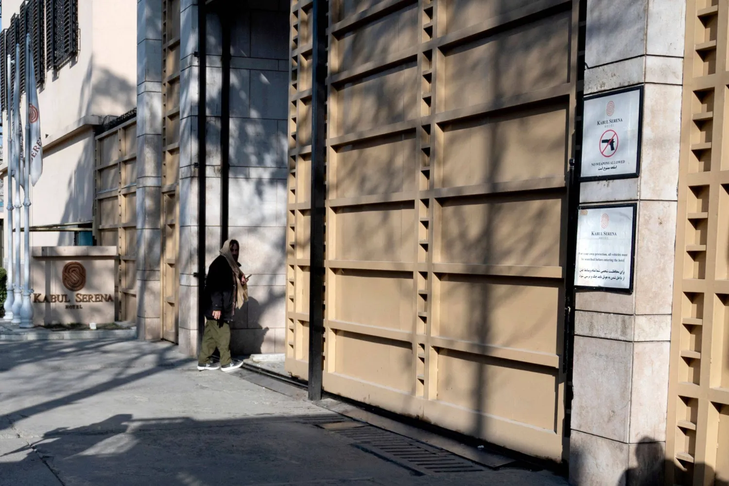 An Afghan security personnel walks near the entry gate of the Kabul Serena Hotel renamed as the Kabul Grand Hotel, in Kabul on February 5, 2025. (Photo by Wakil KOHSAR / AFP)