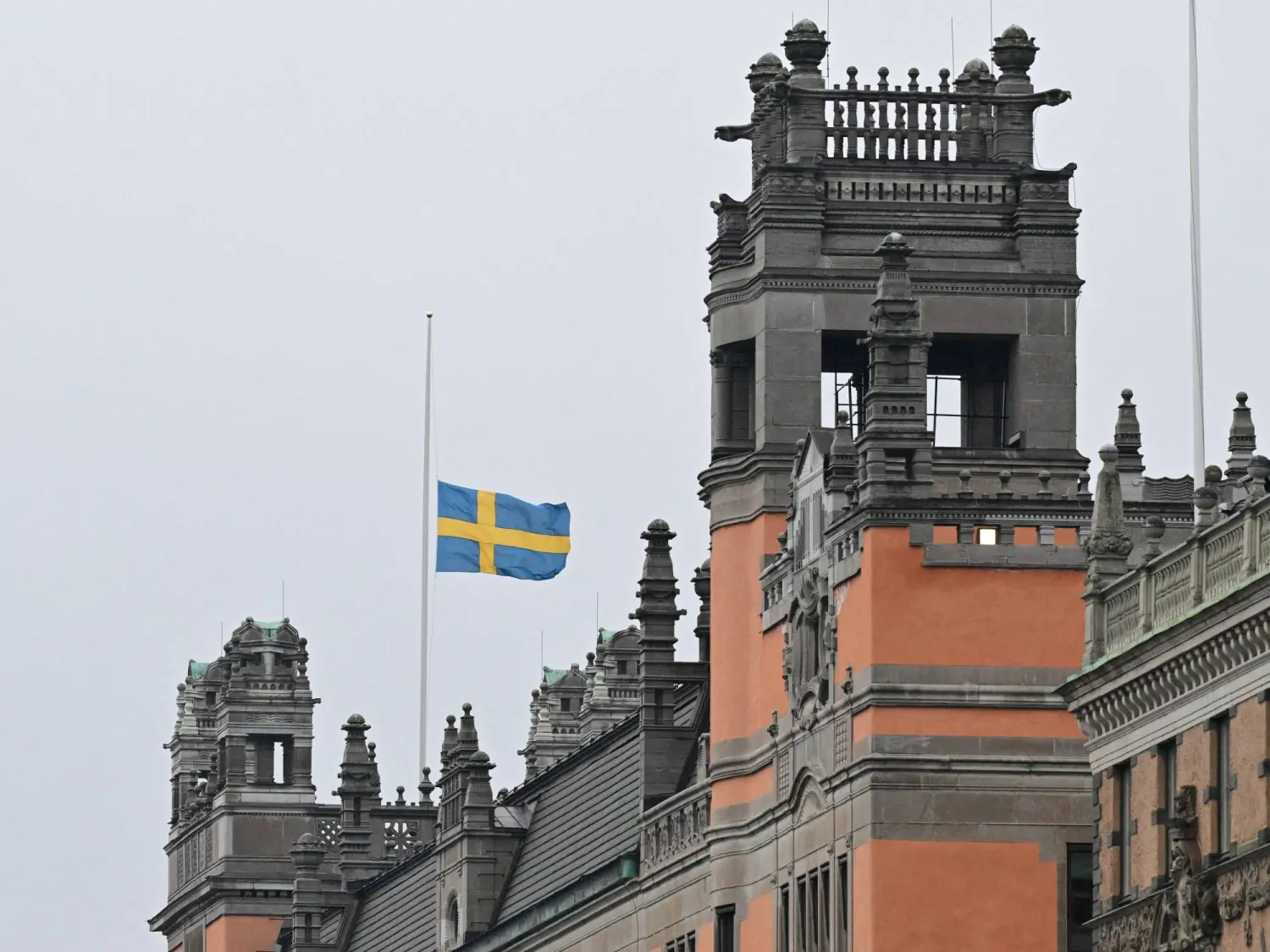 Swedish flag flies at half-mast, following a school shooting in Orebro, on the government offices (Rosenbad) in Stockholm, Sweden February 5, 2025. TT News Agency/Jonas Ekstromer via REUTERS