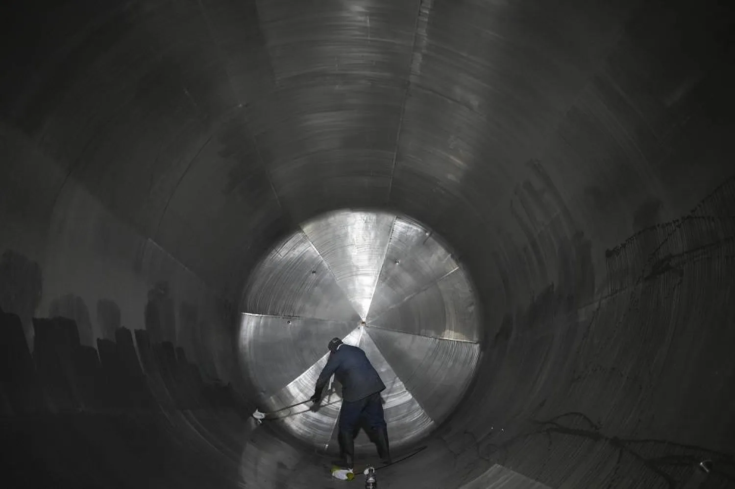 An employee cleans a container at a steel tank factory in Mexico City, Tuesday, Feb. 11, 2025. (AP)