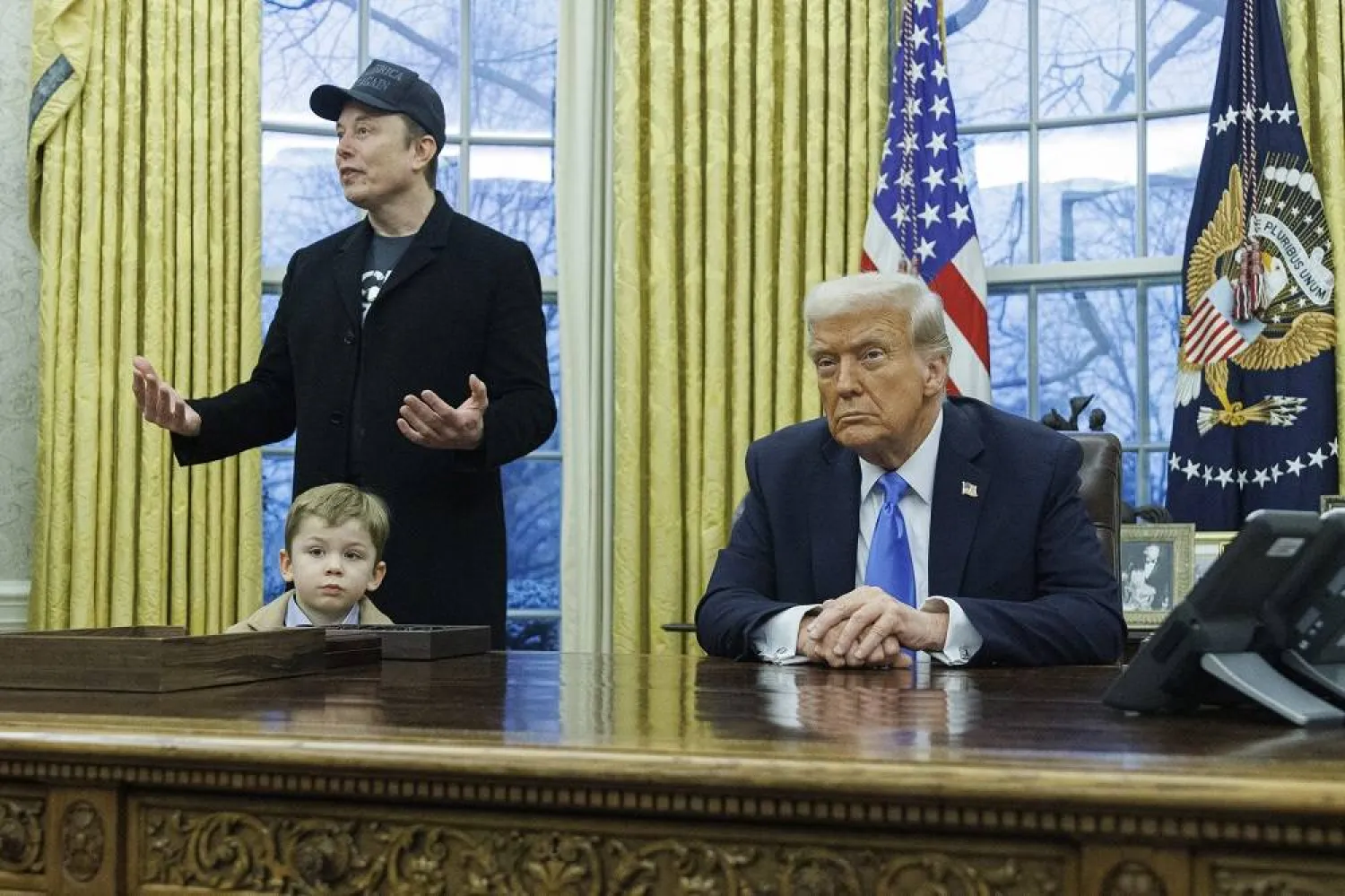 US entrepreneur and US special government employee Elon Musk (L), with his son X, and US President Donald J. Trump (R) talk to media in the Oval Office of the White House in Washington, DC, USA, 11 February 2025. (EPA) 
