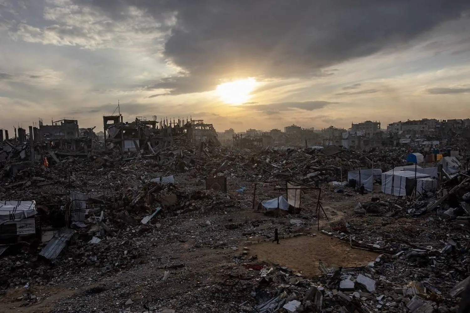 A Palestinian walks among the rubble of destroyed buildings in the Jabalia camp, north of Gaza City, 11 February 2025. (EPA)
