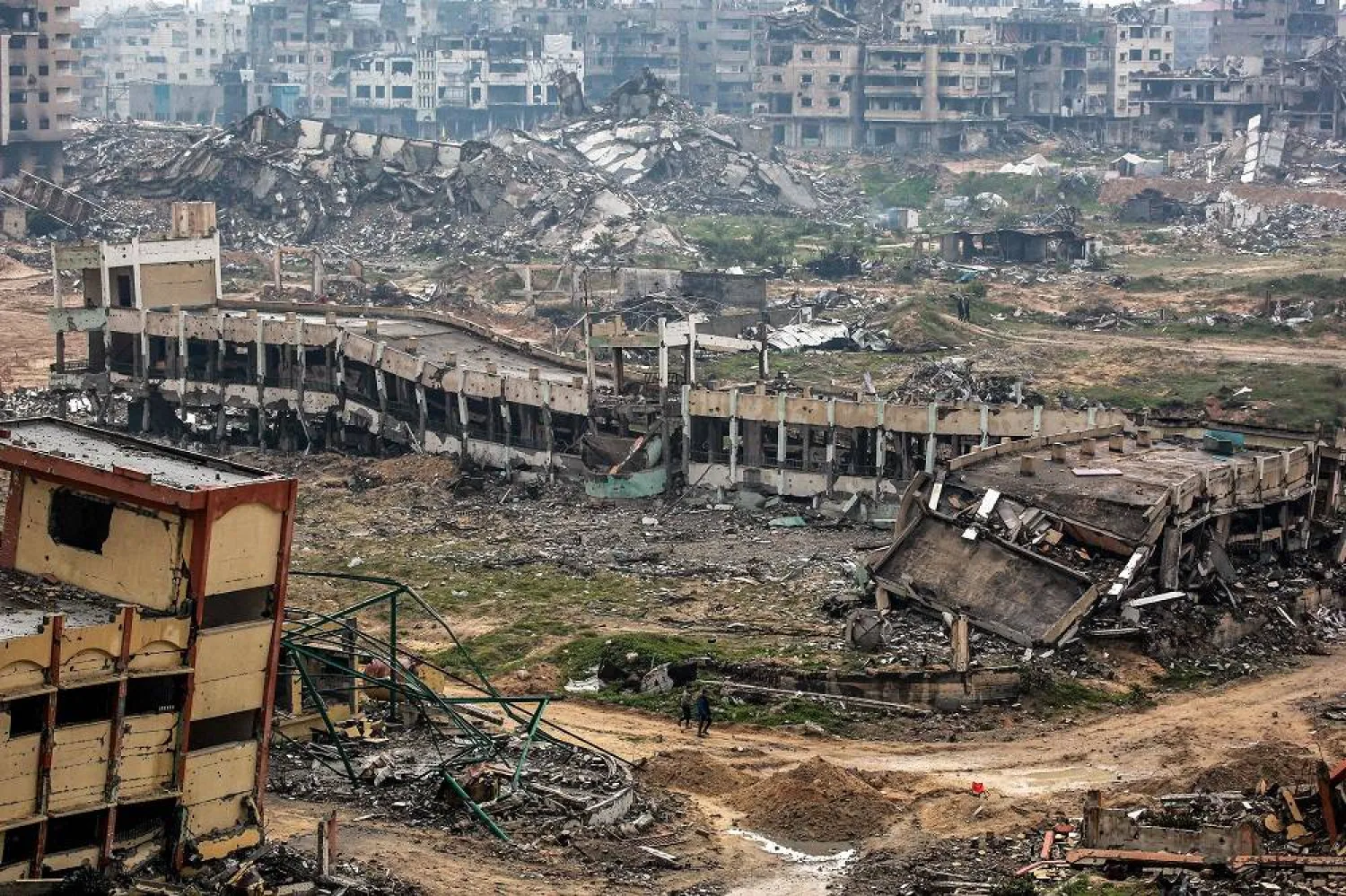 Youths walk past a destroyed secondary school in the north of Gaza City on February 10, 2025 amid the current ceasefire deal in the war between Israel and Hamas. (AFP)