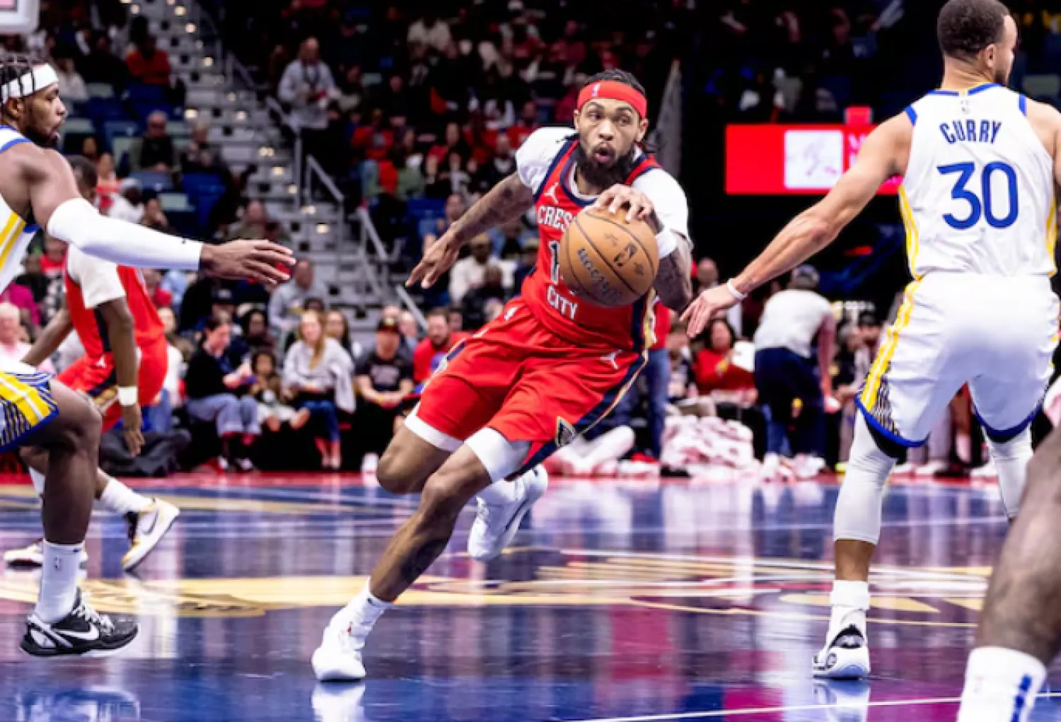 Nov 22, 2024; New Orleans, Louisiana, USA; New Orleans Pelicans forward Brandon Ingram (14) dribbles against Golden State Warriors guard Stephen Curry (30) and guard Buddy Hield (7) during first half at Smoothie King Center. Mandatory Credit: Stephen Lew-Imagn Images/File Photo -Reuters
