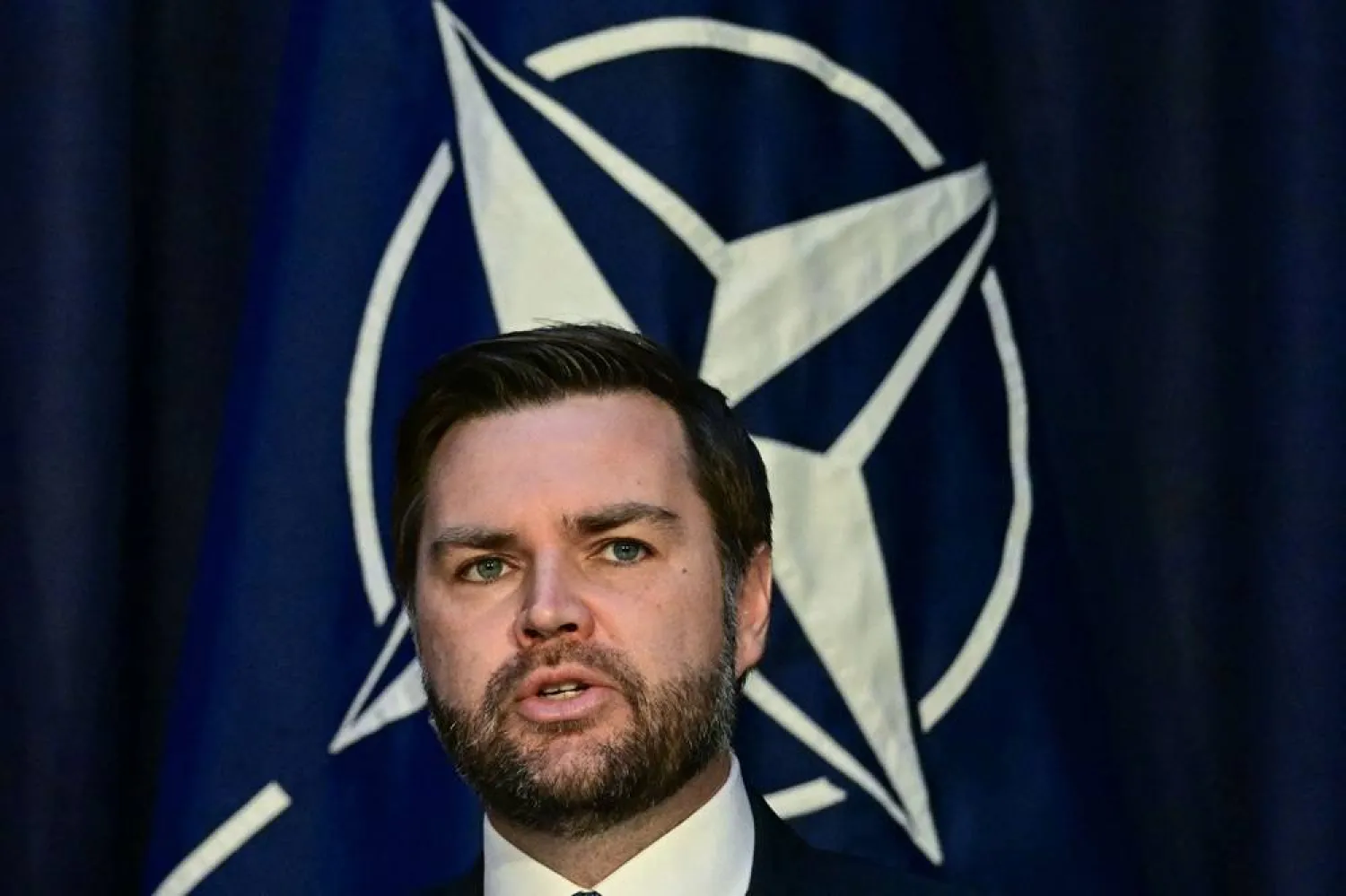  US Vice President JD Vance talks in front of the NATO logo as he meets with the NATO Secretary General (unseen) on the first day of the 61st Munich Security Conference (MSC) in Munich, southern Germany on February 14, 2025. (AFP) 