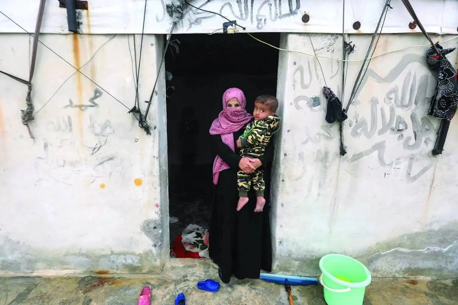 A woman and her child are seen at the Atmeh refugee camp near Idlib in northwestern Syria. (AFP) 