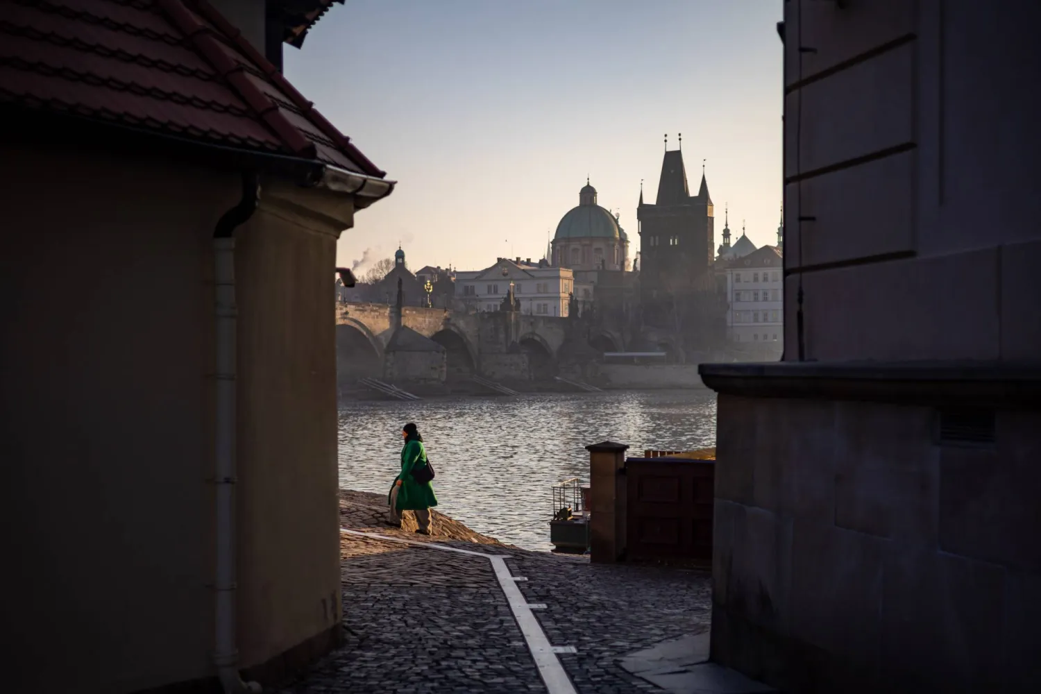 A woman walks near Charles bridge on a winter morning in Prague, Czech Republic, 19 February 2025. EPA/MARTIN DIVISEK