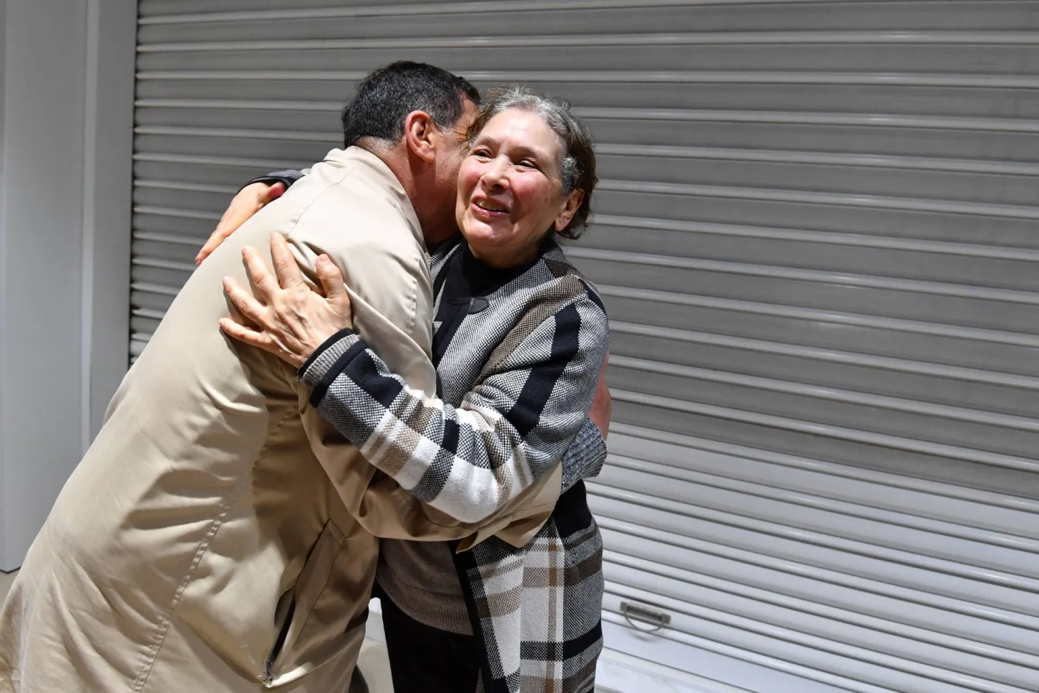 Prominent Tunisian human rights activist Sihem Ben Sedrine is surrounded by her lawyer Ayachi Hamami, upon her release from jail in Manouba near Tunis on February 19, 2025. (Photo by FETHI BELAID / AFP)