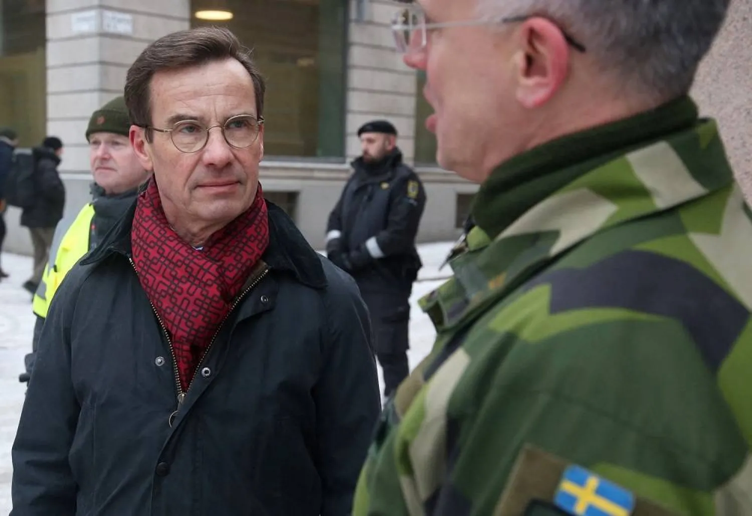 Swedish Prime Minister Ulf Kristersson talks to an officer as he visits troops taking part in exercises in central Stockholm, Sweden, February 17, 2025. (Reuters)