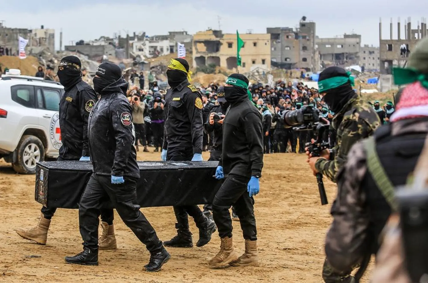  20 February 2025, Palestinian Territories, Khan Younis: Palestinian Hamas members carry one of the four coffins during the handover of the bodies of four Israeli hostages, killed in the Israeli war on Gaza, to the Red Cross in Khan Younis. (dpa)