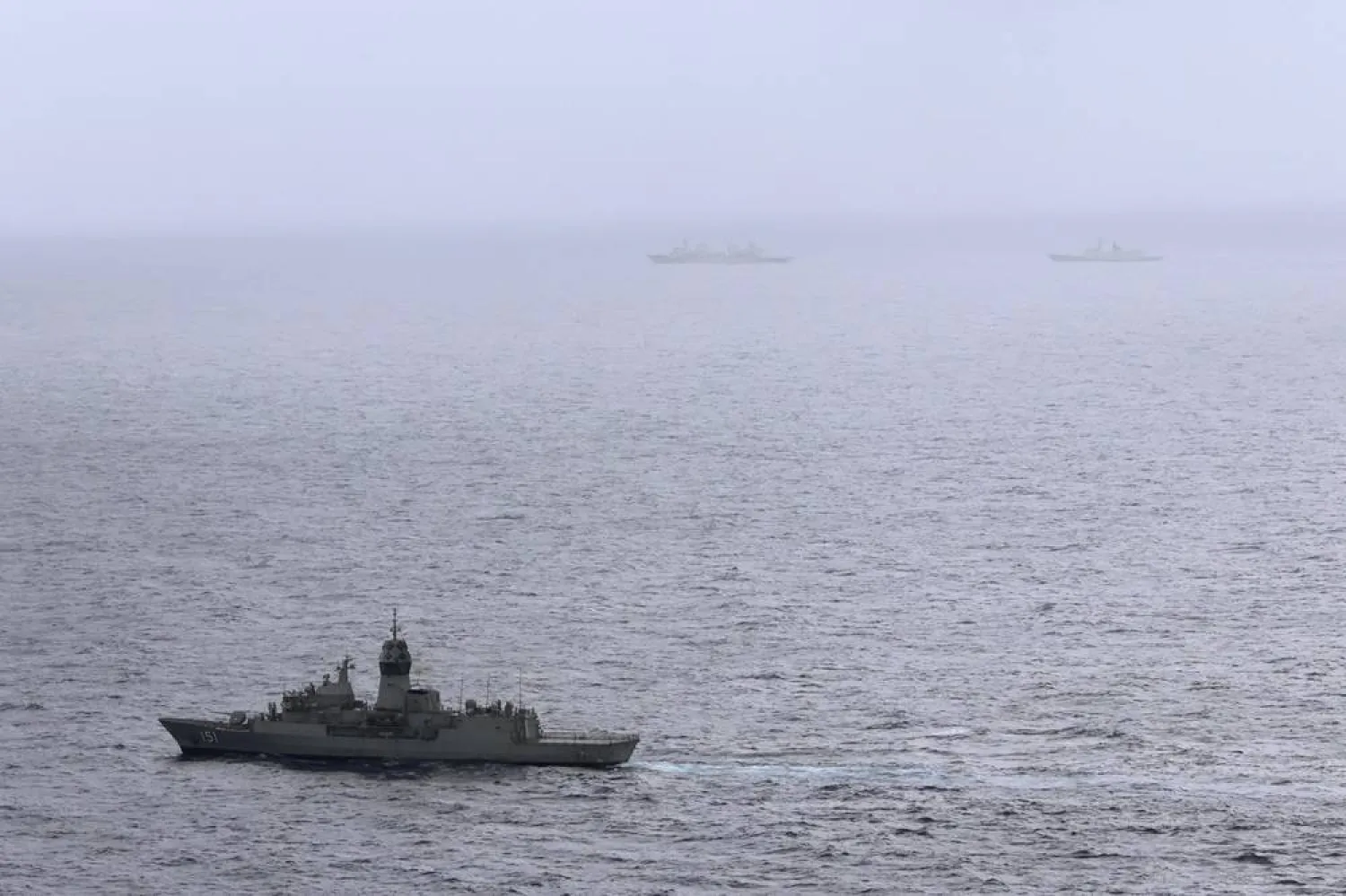 In this photo provided by the Australian Defense Force, the HMAS (His Majesty's Australian Ship) Arunta, left, shadows the People's Liberation Army-Navy Jiangkai-class frigate Hengyang and a Fuchi-class replenishment vessel in the Tasman Sea, on Feb. 13, 2025. (Australian Defense Force via AP) 