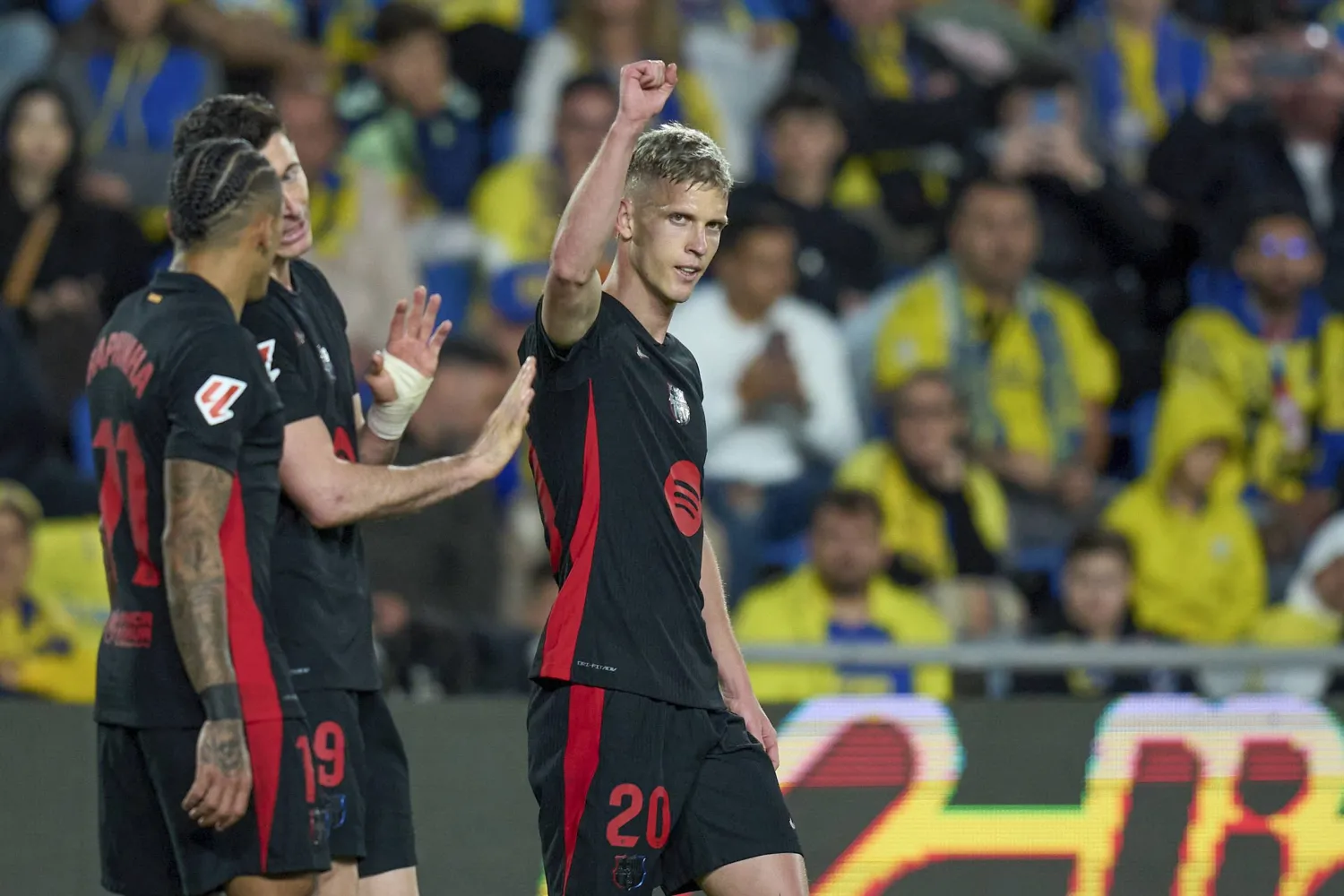 Barcelona's Dani Olmo, right, celebrates with teammates after scoring opening goal during the Spanish La Liga soccer match between Las Palmas and Barcelona at the Gran Canaria stadium in Las Palmas, Spain's Canary Islands, Saturday, Feb. 22, 2024. (AP Photo/Gabriel Jimenez)