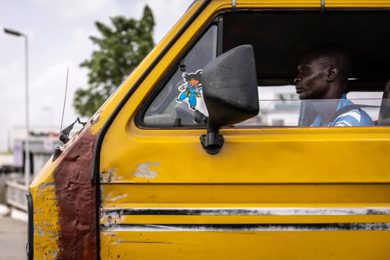 A man drives a Danfo, a mini-bus, in Lagos, on February 21, 2025. (Photo by OLYMPIA DE MAISMONT / AFP)