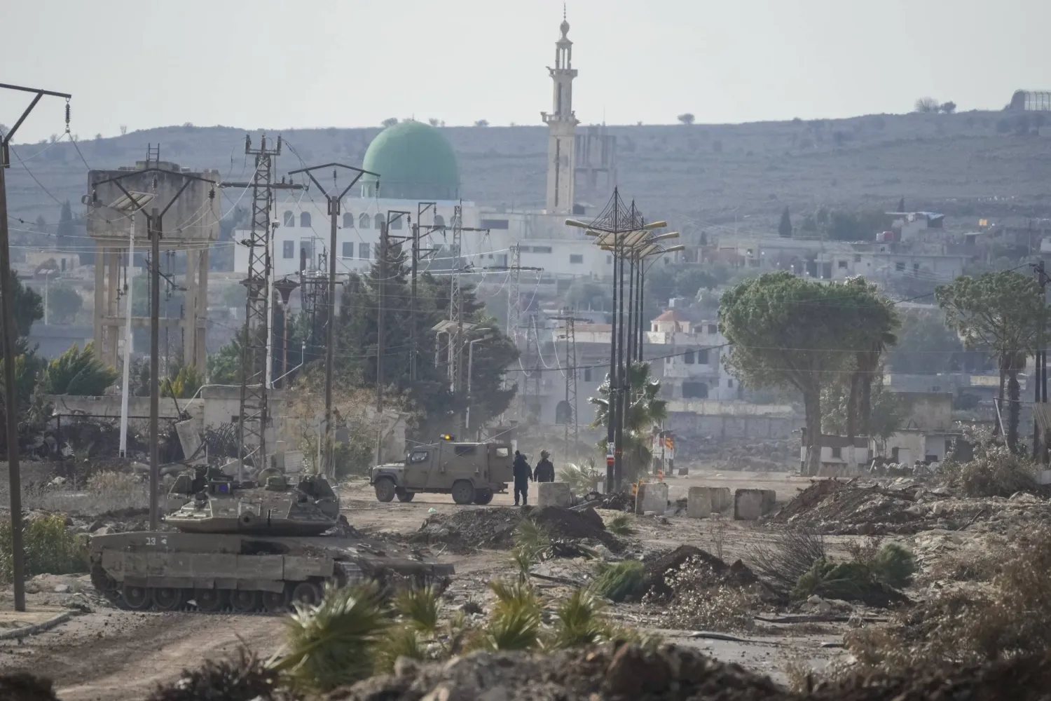 FILE - Israeli army armored vehicles block a road leading to the town of Quneitra, Syria, Jan. 5, 2025. (AP Photo/Mosa'ab Elshamy, File)