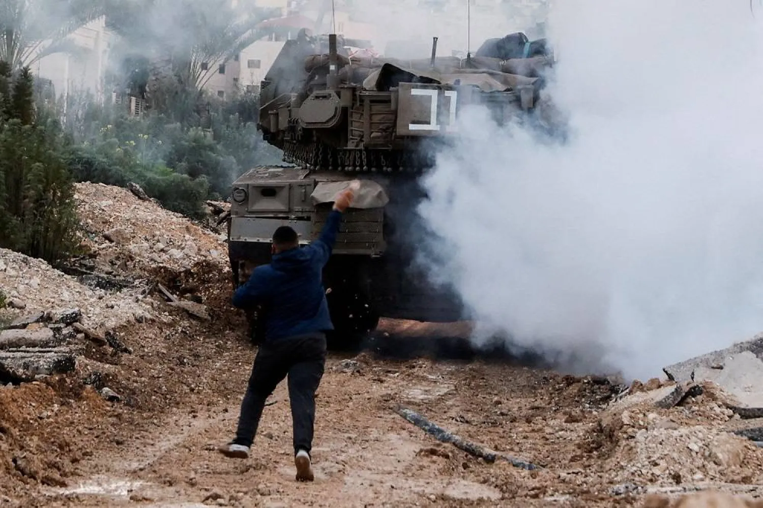 A man reacts next to an Israeli tank during an Israeli operation in Jenin, in the Israeli-occupied West Bank, February 23, 2025. (Reuters)