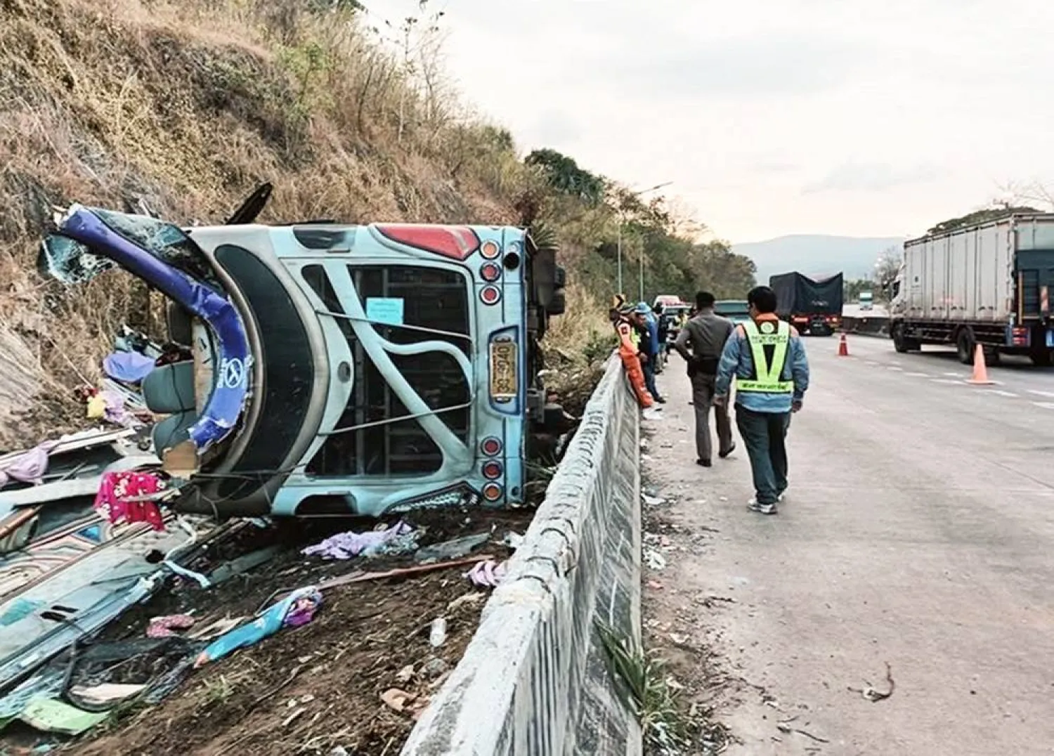 A handout photo made available by the Thai Highway Police shows the wreckage of a bus that overturned after it crashed, at an accident site on a downhill road in Nadi district, Prachin Buri province, about 150 kilometers east of Bangkok, Thailand, 26 February 2025. (EPA/ Thai Highway Police/ Handout) 