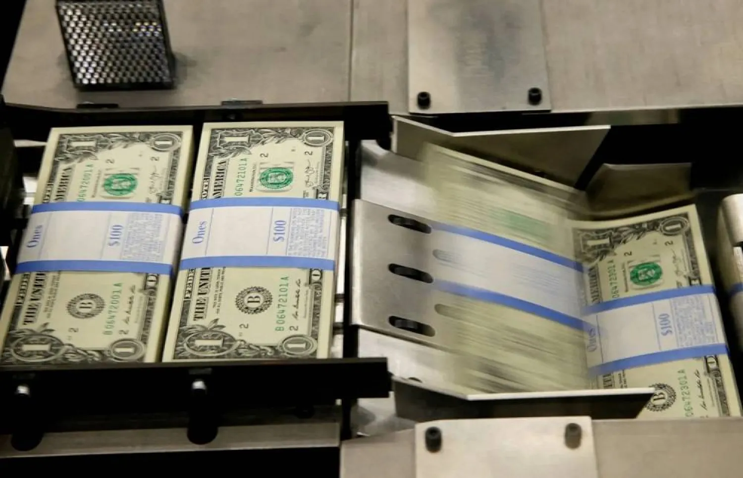 One dollar bills are put in packaging bands during production at the Bureau of Engraving and Printing in Washington November 14, 2014. (Reuters)  