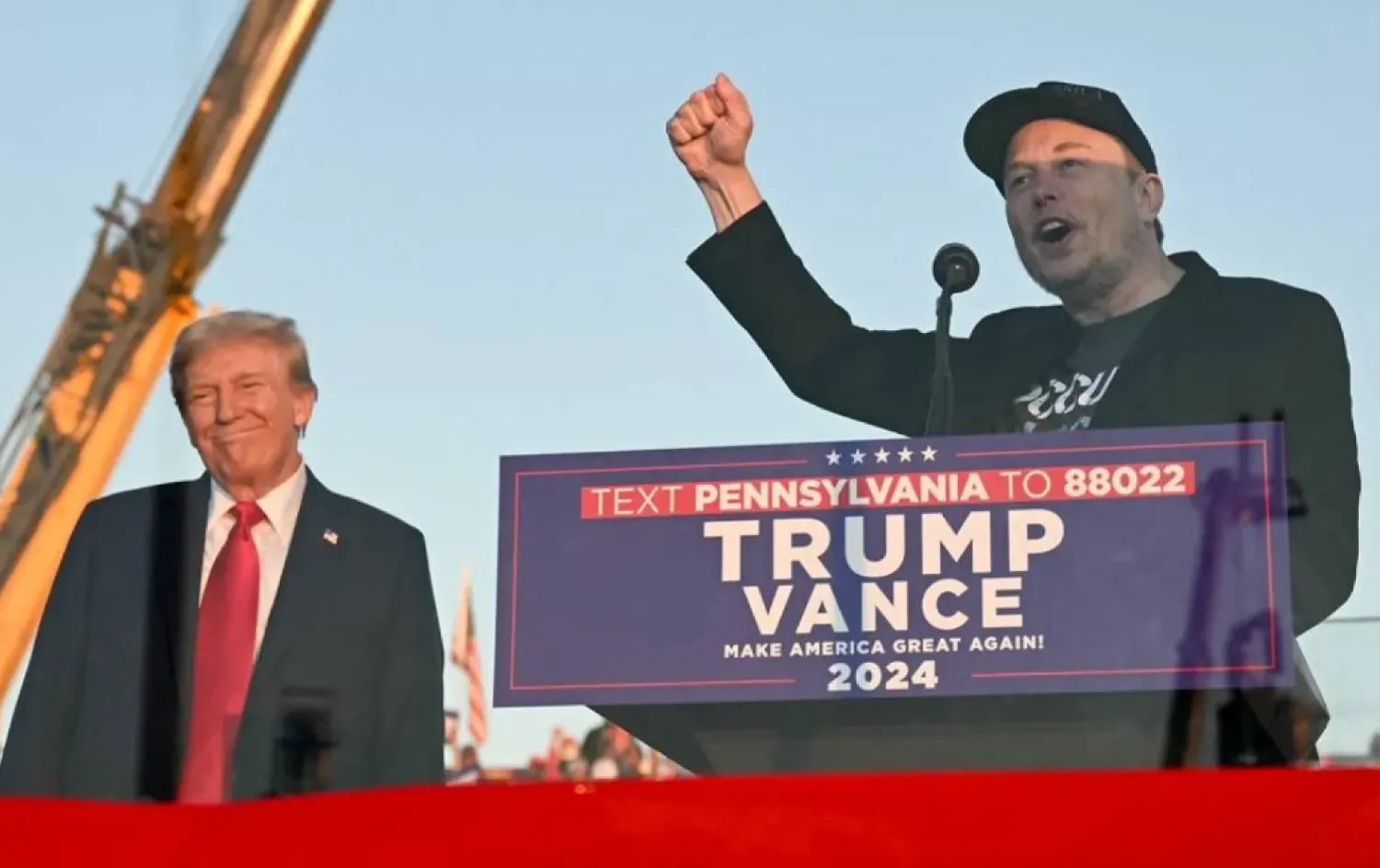 Tesla CEO Elon Musk (R) speaks on stage as he joins former US President and Republican presidential candidate Donald Trump during a campaign rally at site of his first assassination attempt in Butler, Pennsylvania on October 5, 2024. (AFP)
