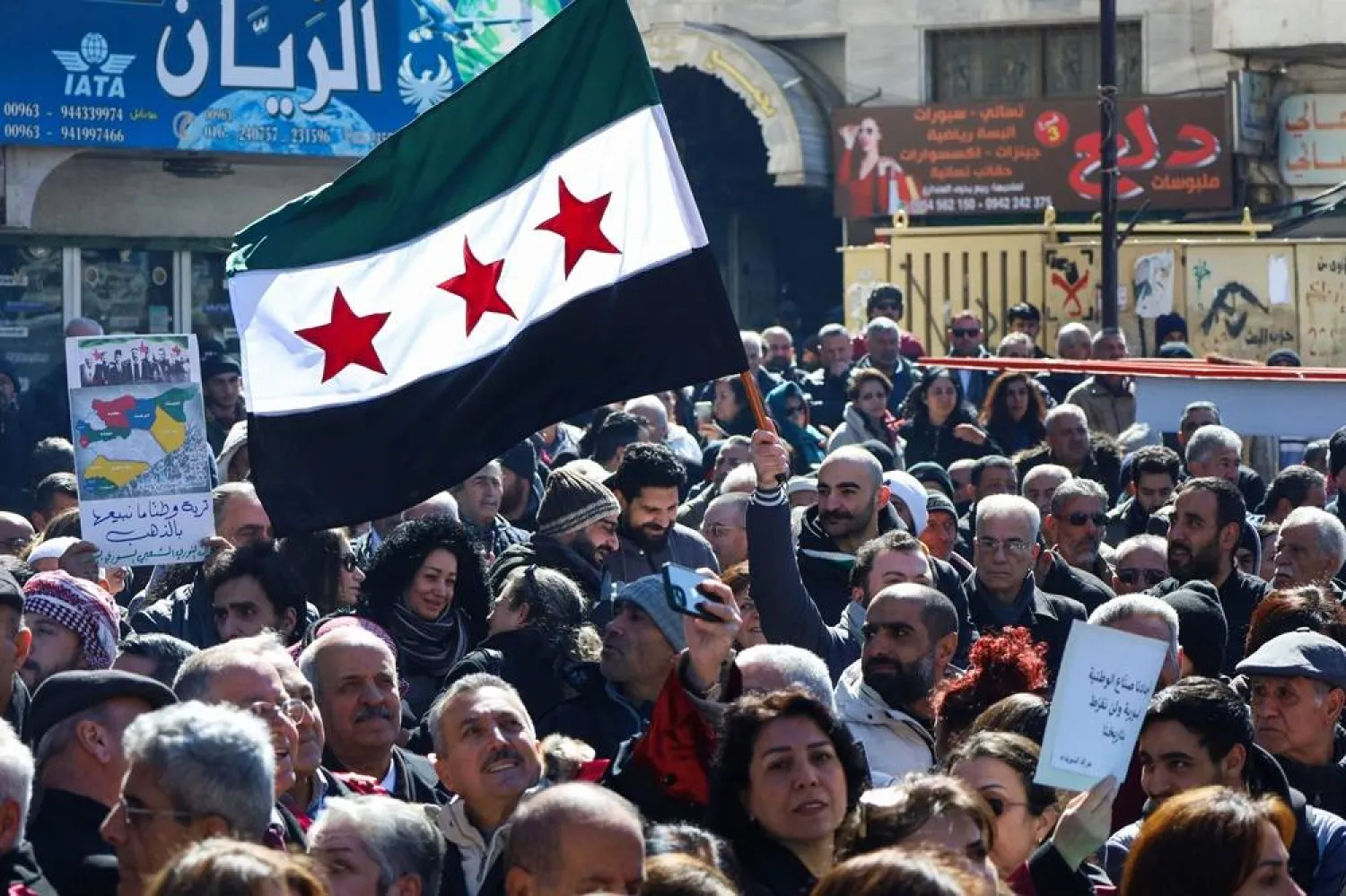 Syrians lift placards as they demonstrate in the central Karama Square of the southern city of Sweida on February 25, 2025, in rejection of statements made by Israel's premier on the weekend. (AFP)