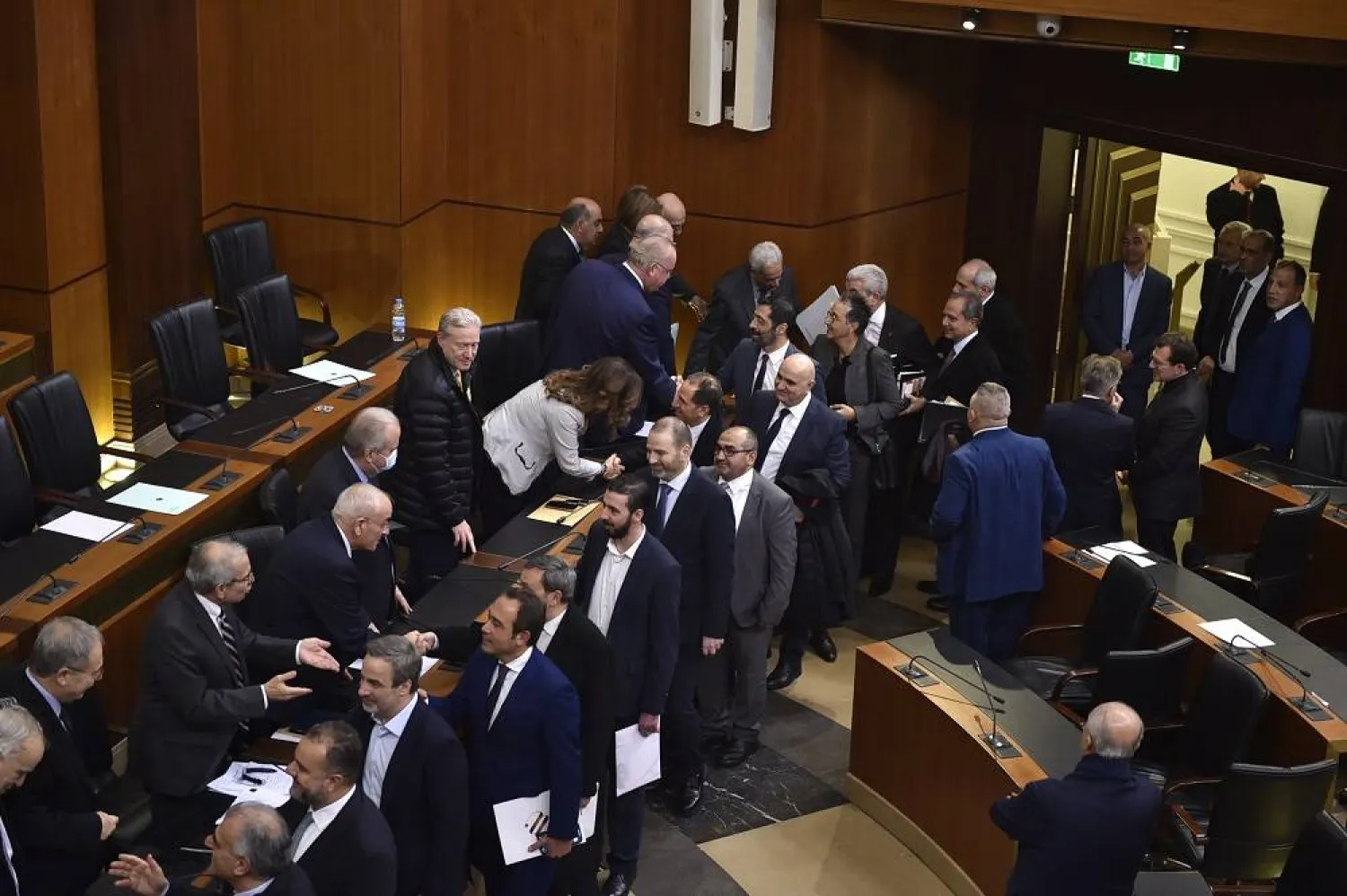 Members of the new government receive applauds from parliament members after winning the vote of confidence at the parliament building in Beirut, Lebanon, Wednesday, Feb. 26, 2025. (Lebanese Parliament Media Office via AP)