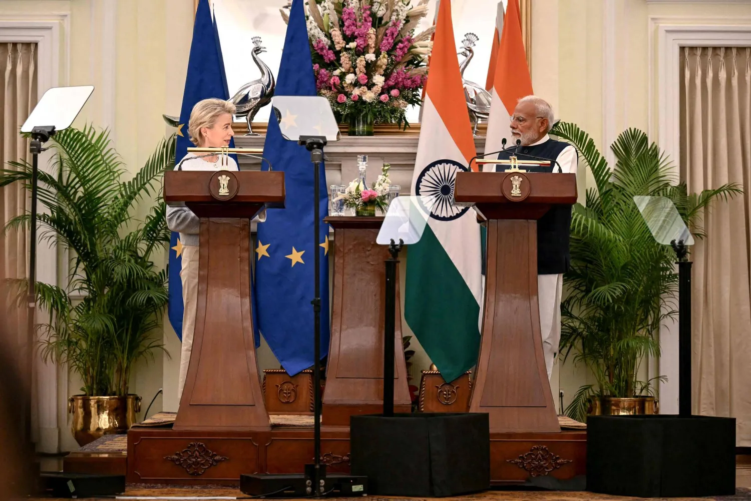 European Commission President Ursula von der Leyen (L) addresses a joint press briefing as India's Prime Minister Narendra Modi listens, after their meeting at the Hyderabad House in New Delhi on February 28, 2025. (Photo by Money SHARMA / AFP)
