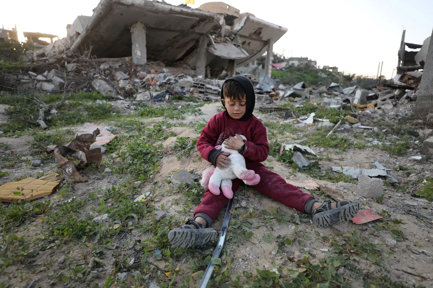 Mohammed, 5, who was displaced with his family to the southern part of Gaza, plays with a toy retrieved from under the rubble of their house, after returning to it amid a ceasefire between Israel and Hamas, in Jabalia, northern Gaza Strip, January 30, 2025. (Reuters) 