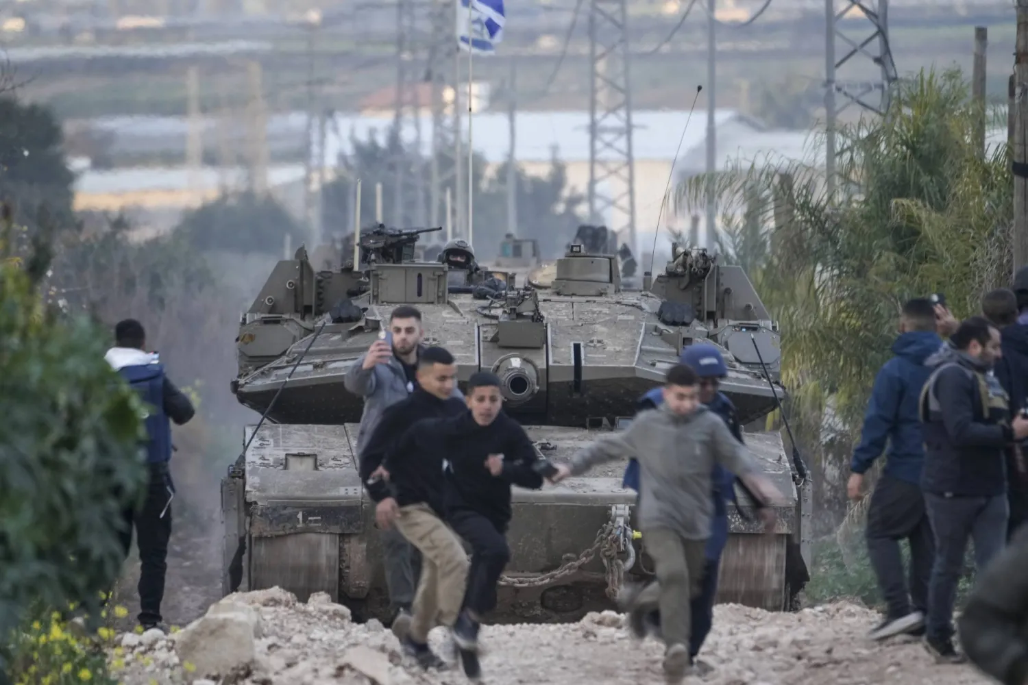 Israeli soldiers drive a tank towards the occupied West Bank of Jenin camp, during an ongoing army operation, Feb. 23, 2025. (AP Photo/Majdi Mohammed)