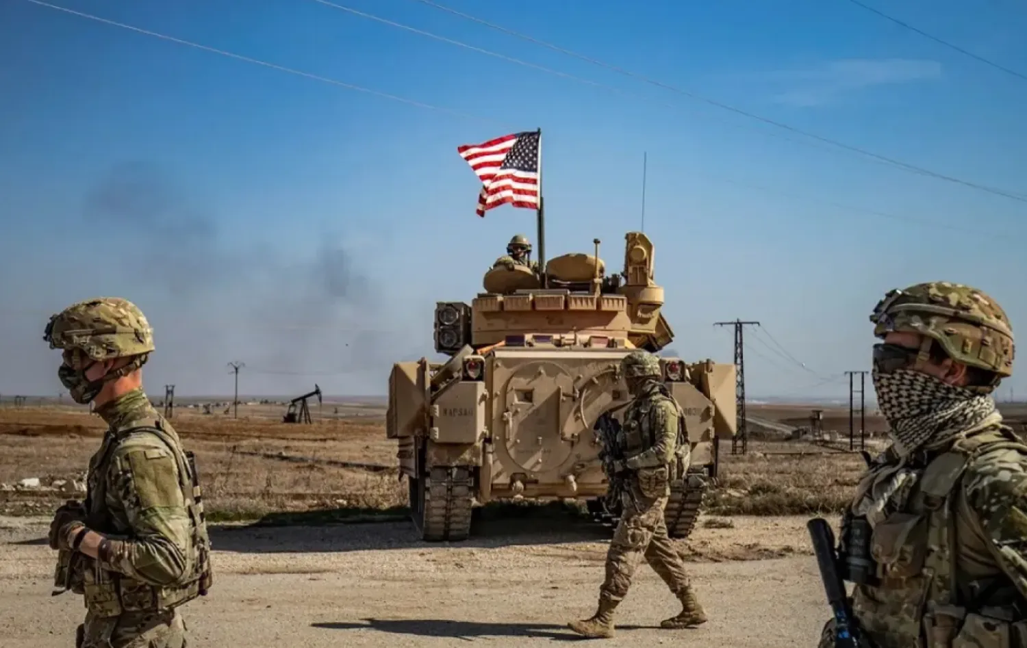 US soldiers walk while on patrol by the Suwaydiyah oil fields in Syria's northeastern Hasakah province on February 13, 2021. (AFP)

