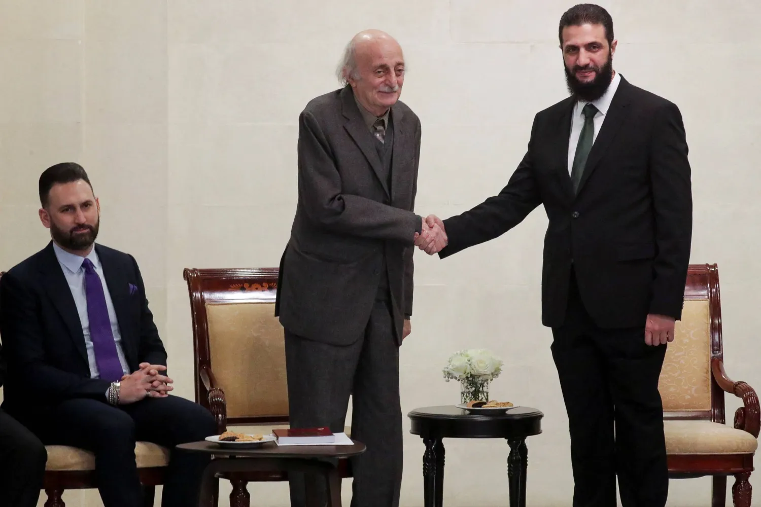 Lebanese Druze leader Walid Jumblatt shakes hands with Syria's de facto leader Ahmed al-Sharaa, also known as Abu Mohammed al-Golani, next to Jumblatt's son Taymur, after the ousting of Syria's Bashar al-Assad, in Damascus, Syria, December 22, 2024. REUTERS/Khalil Ashawi