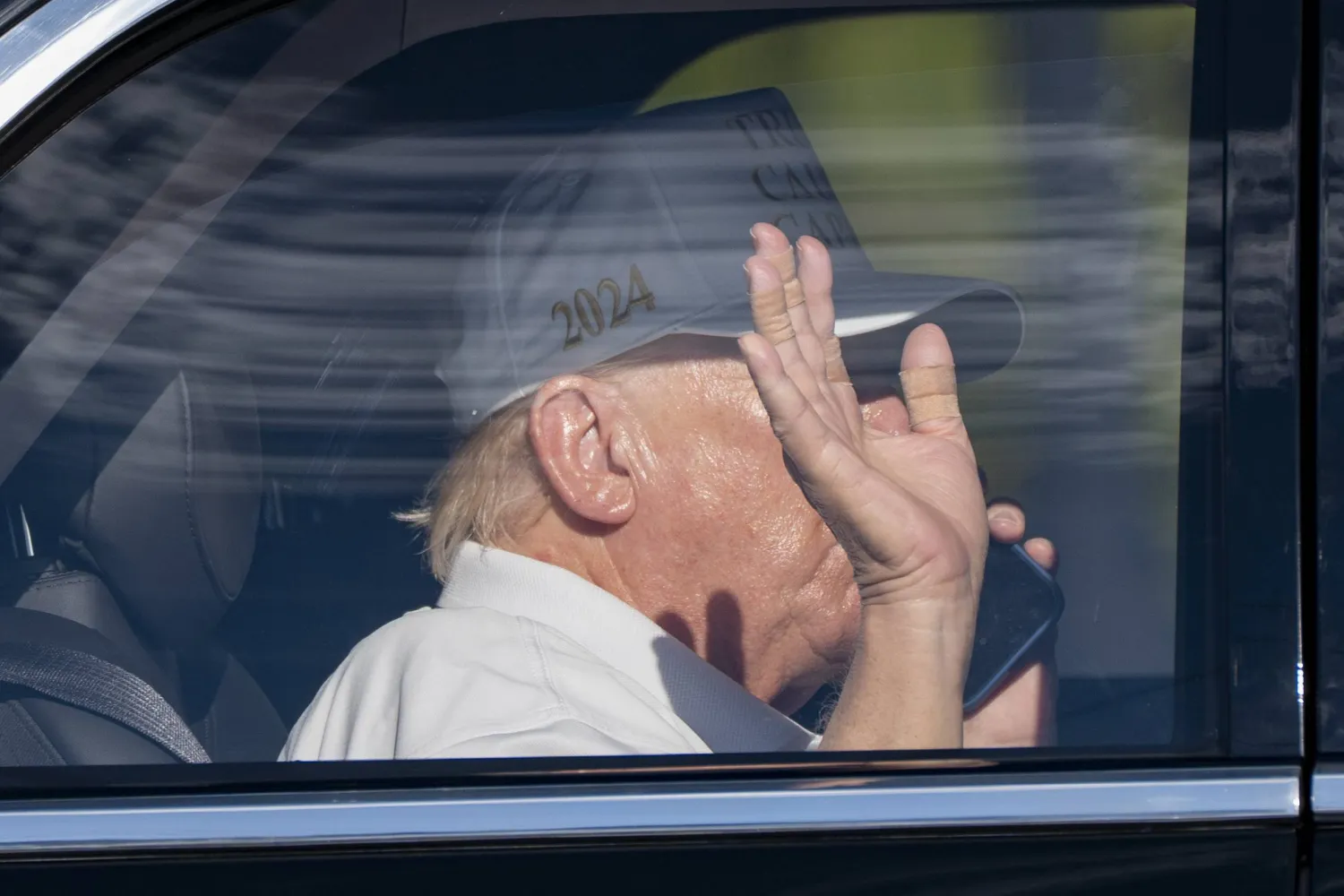 President Donald Trump waves and talks on the phone as he arrives at the Trump International Golf Club, Sunday, March 2, 2025, in West Palm Beach, Fla. (AP Photo/Alex Brandon)