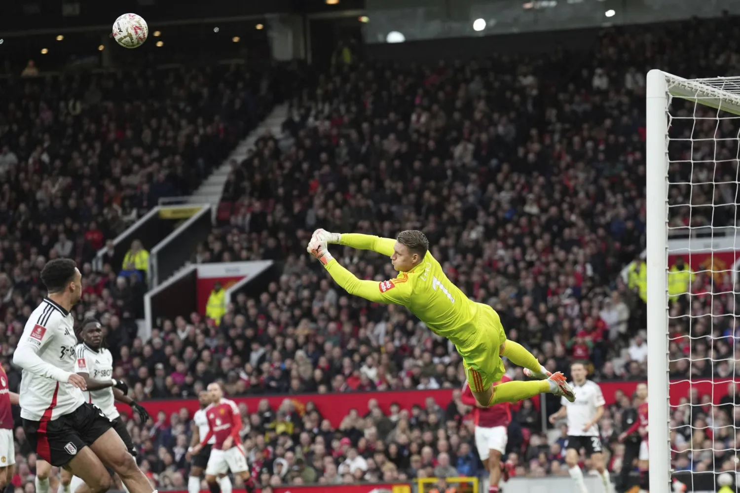 Fulham's goalkeeper Bernd Leno makes a save during the English FA Cup soccer match between Manchester United and Fulham at Old Trafford, Manchester, England, Sunday, March 2, 2025. (AP Photo/Jon Super)