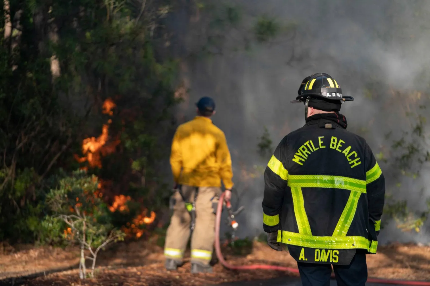 MYRTLE BEACH, SOUTH CAROLINA - MARCH 02: Firefighters attend to a flare-up in the Carolina Forest neighborhood on March 2, 2025 in Myrtle Beach, South Carolina. AFP
