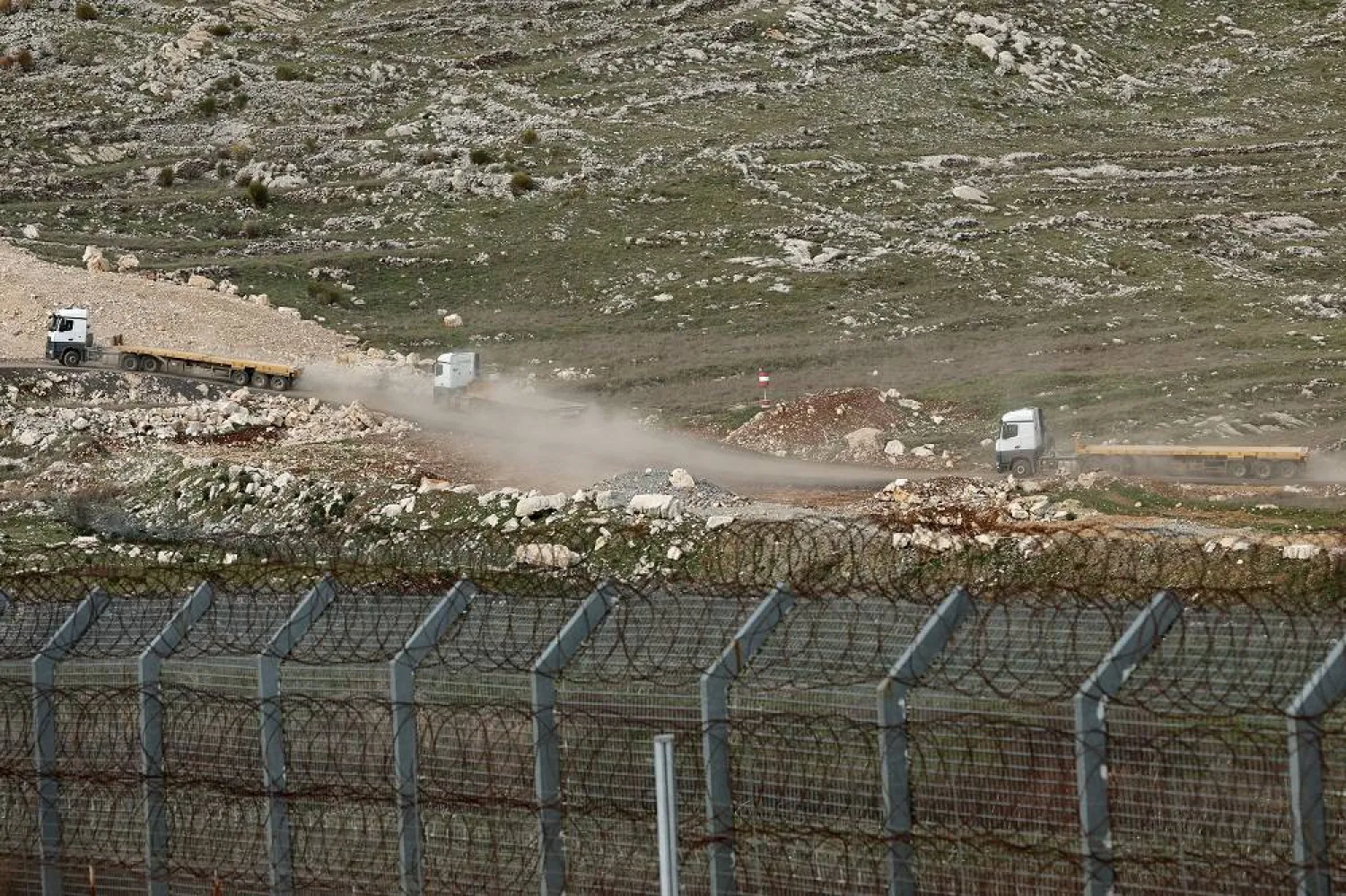 Israeli army trucks pass the buffer zone on the border between Israel and Syria, near the Druze village of Majdal Shams, in the Israeli-occupied Golan Heights, 03 March 2025. (AFP)