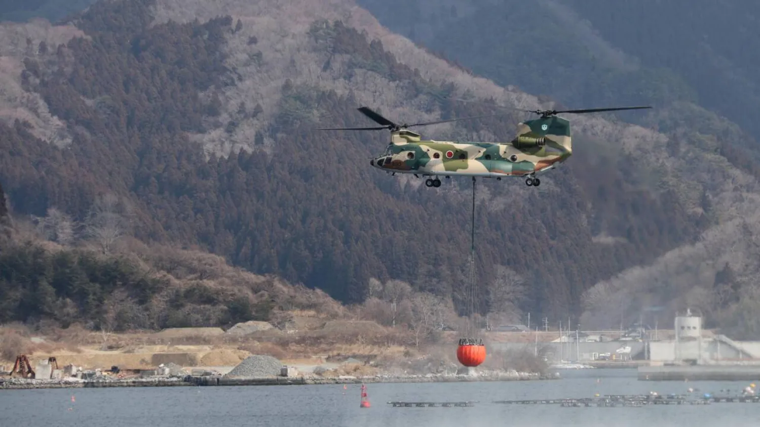 Military and fire department helicopters have been trying to douse the wildfire. Handout / Japan's Ministry of Defense/AFP
