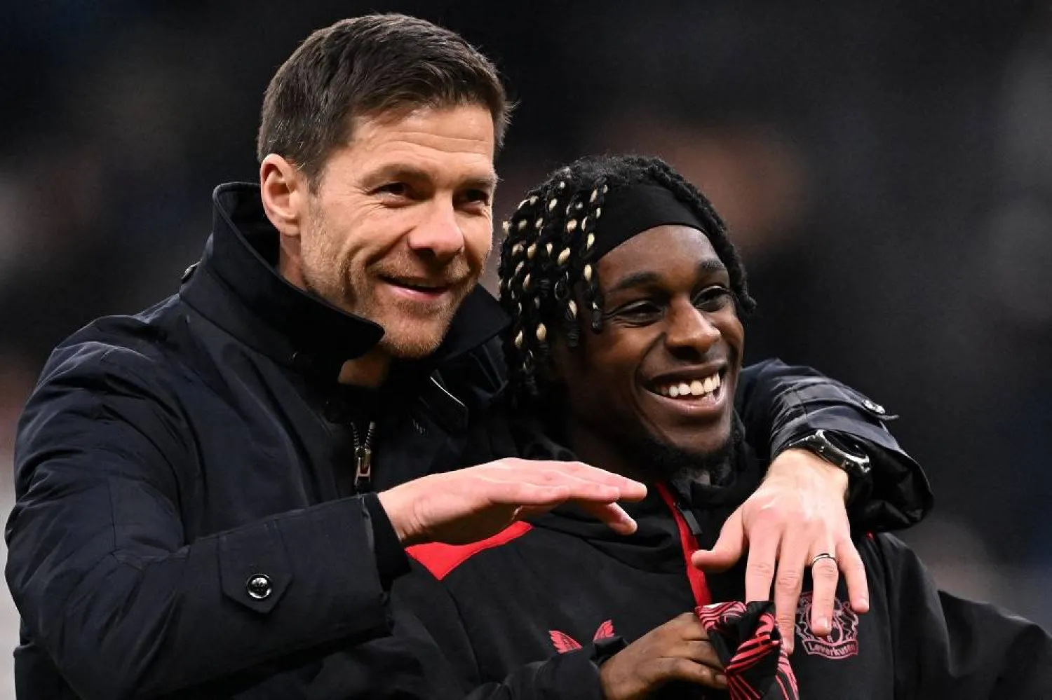 Bayer Leverkusen's Spanish head coach Xabi Alonso (L) and Bayer Leverkusen's Dutch defender #30 Jeremie Frimpong react after the German first division Bundesliga football match between Eintracht Frankfurt and Bayer 04 Leverkusen in Frankfurt on March 1, 2025. (AFP) 