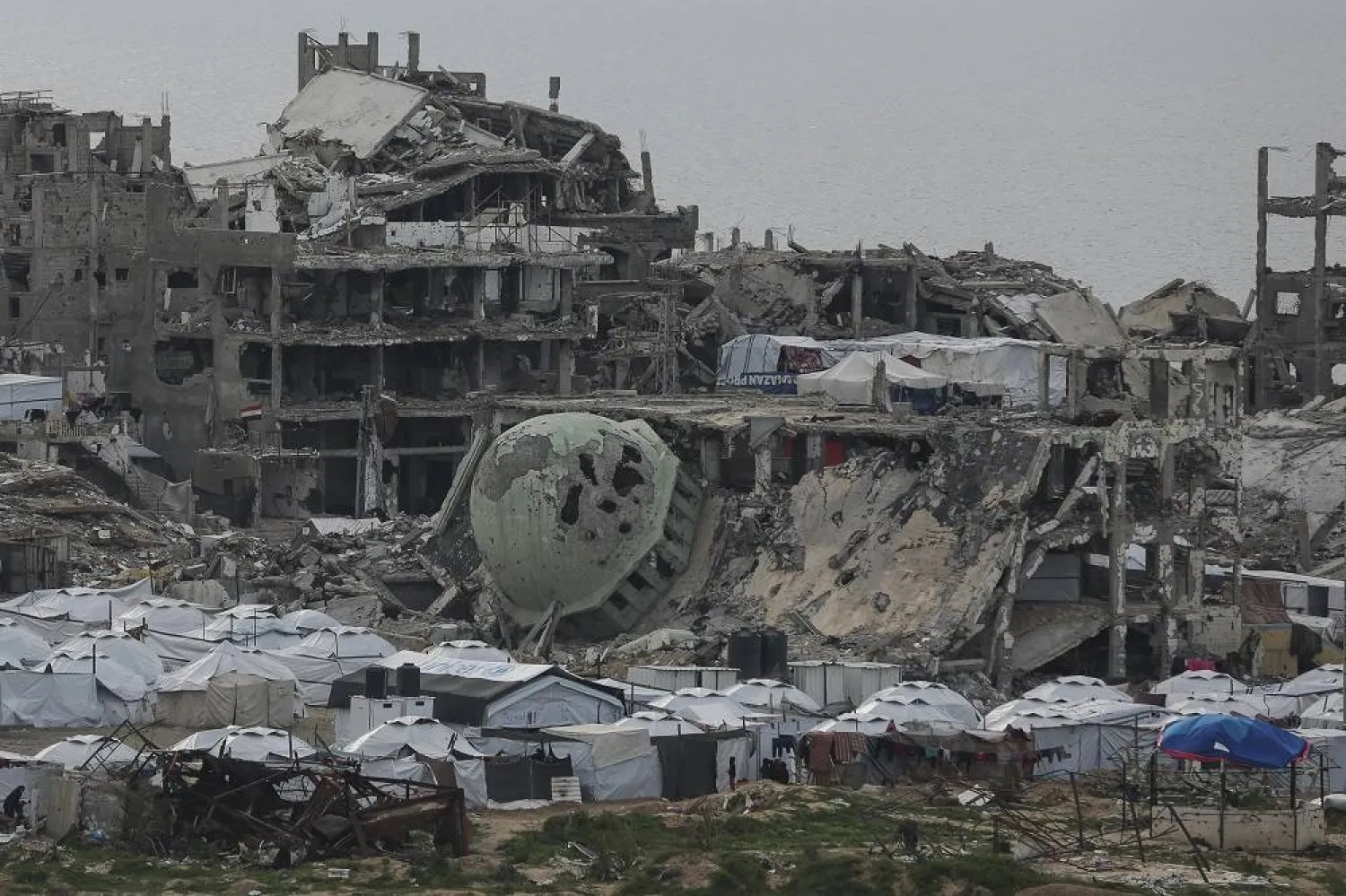 A tent camp for displaced Palestinians is set up amid destroyed buildings in the west of Al-Shati camp, west of Gaza City, on Monday, March 3, 2025. (AP)