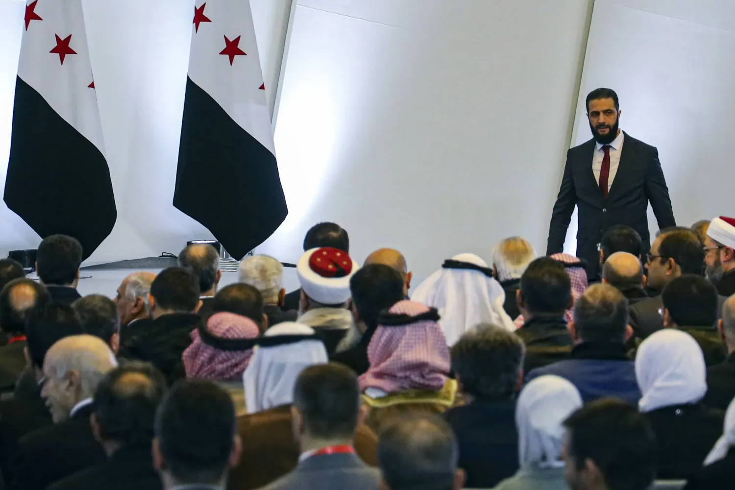 أحمد الشرع عقب كلمته في افتتاح مؤتمر الحوار الوطني الشهر الماضي (أ.ف.ب)